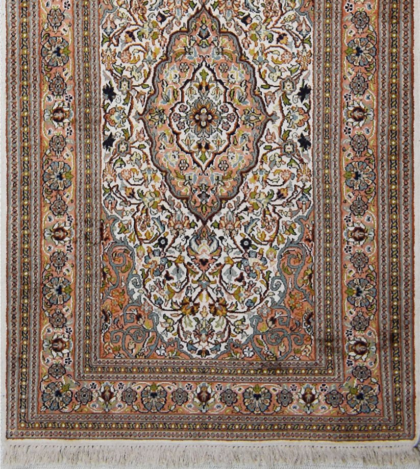 A handmade Kashmiri silk runner featuring an intricate floral Persian pattern in soft pastel tones.