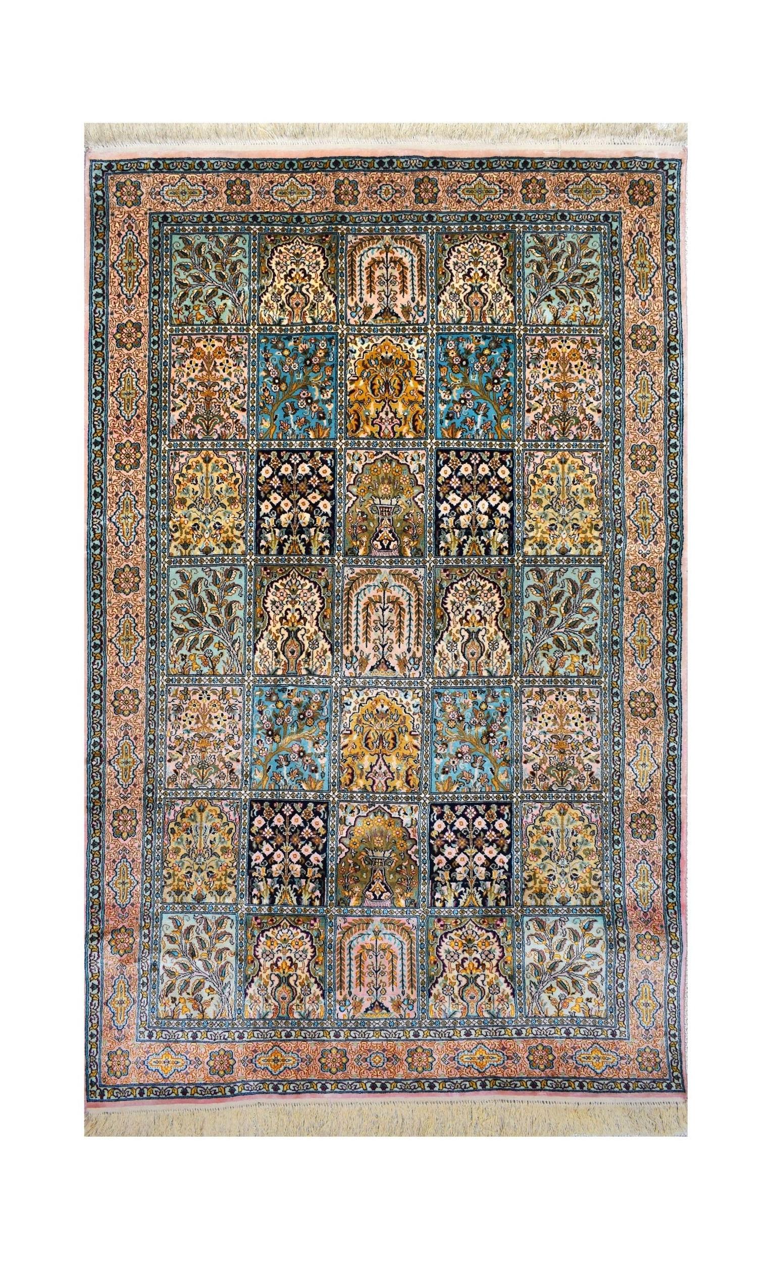 A rectangular handmade Kashmiri silk rug featuring a grid of intricate floral and vase motifs.