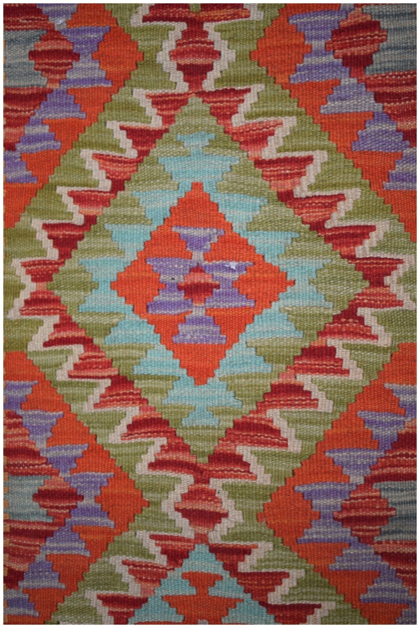 Handmade Afghan Maimana kilim runner featuring a vibrant geometric diamond pattern in wool.