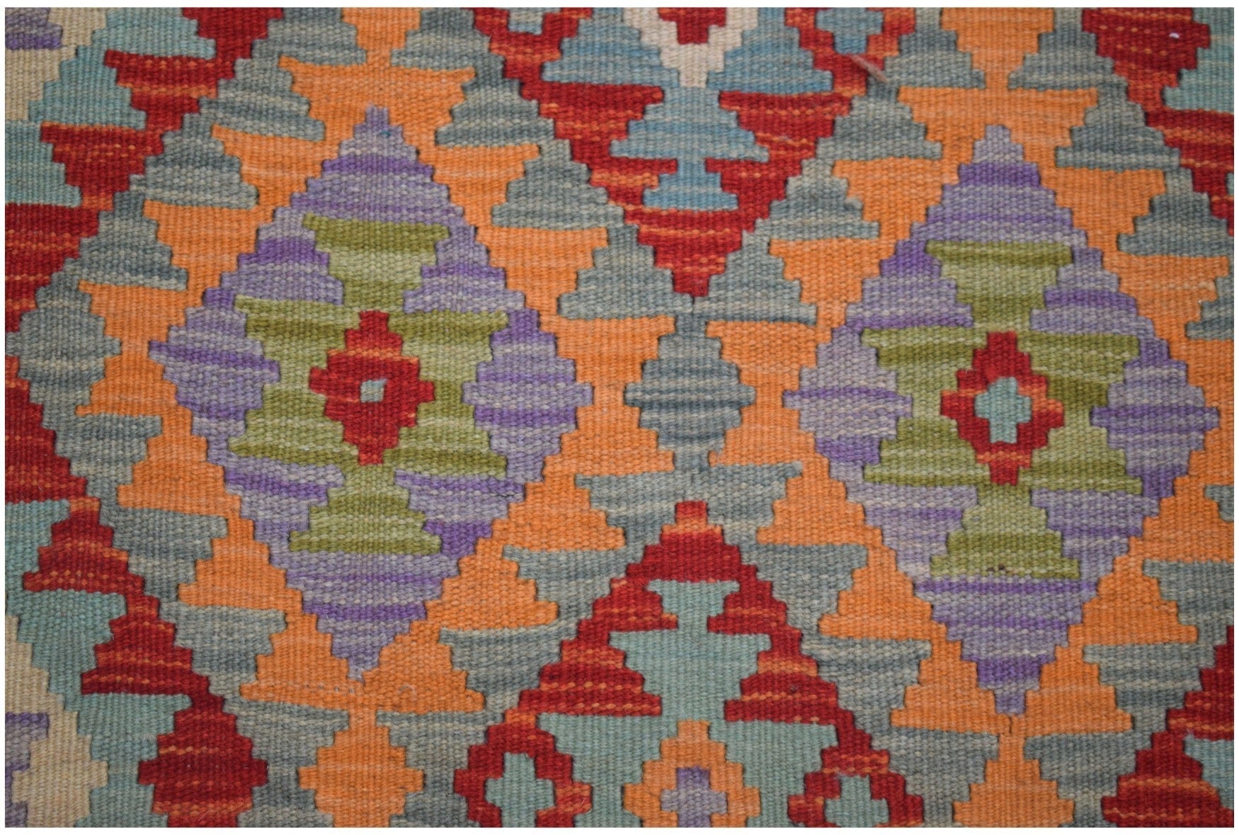 Handmade Afghan Maimana kilim runner featuring a geometric diamond pattern in vibrant colors.