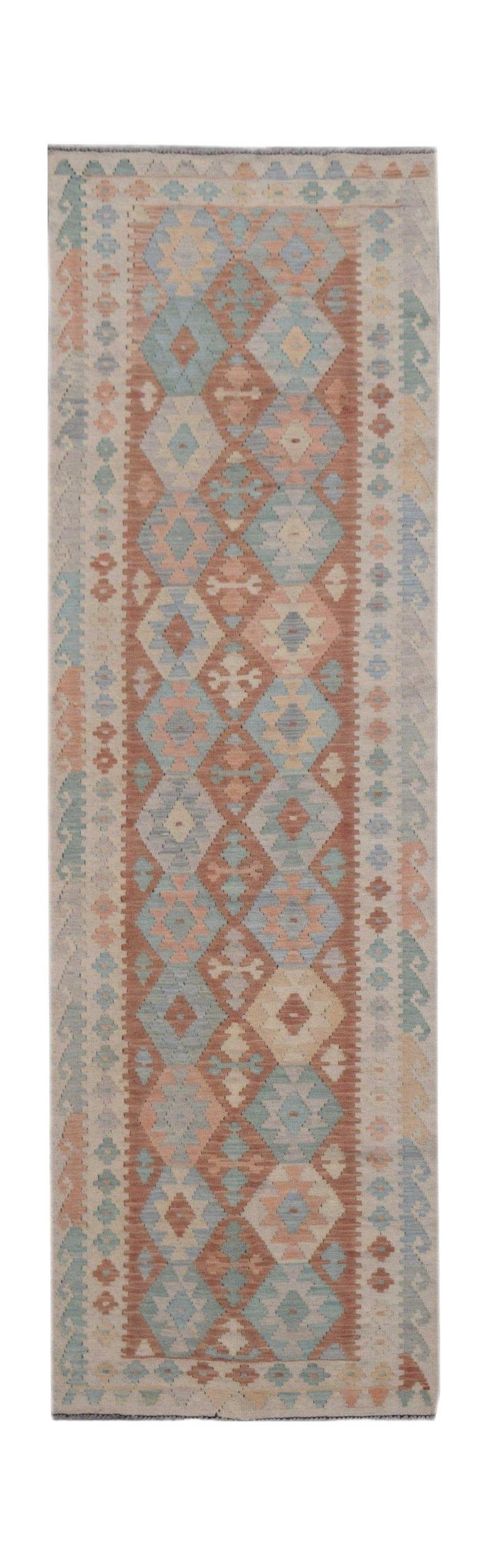 Handmade Afghan Maimana wool runner rug featuring a geometric diamond pattern in muted tones.