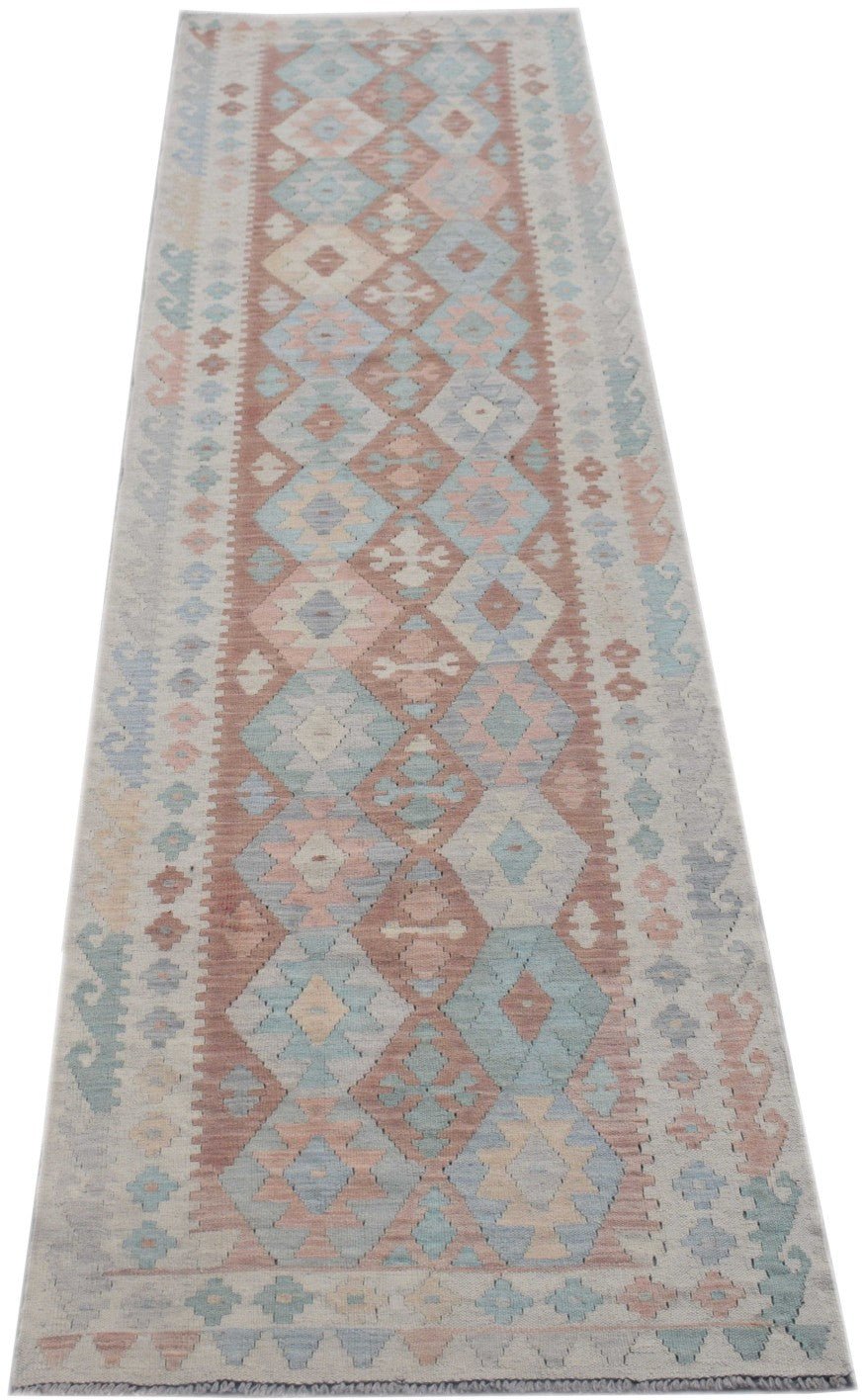 A handmade Afghan Maimana wool runner rug featuring a geometric diamond pattern in muted tones.