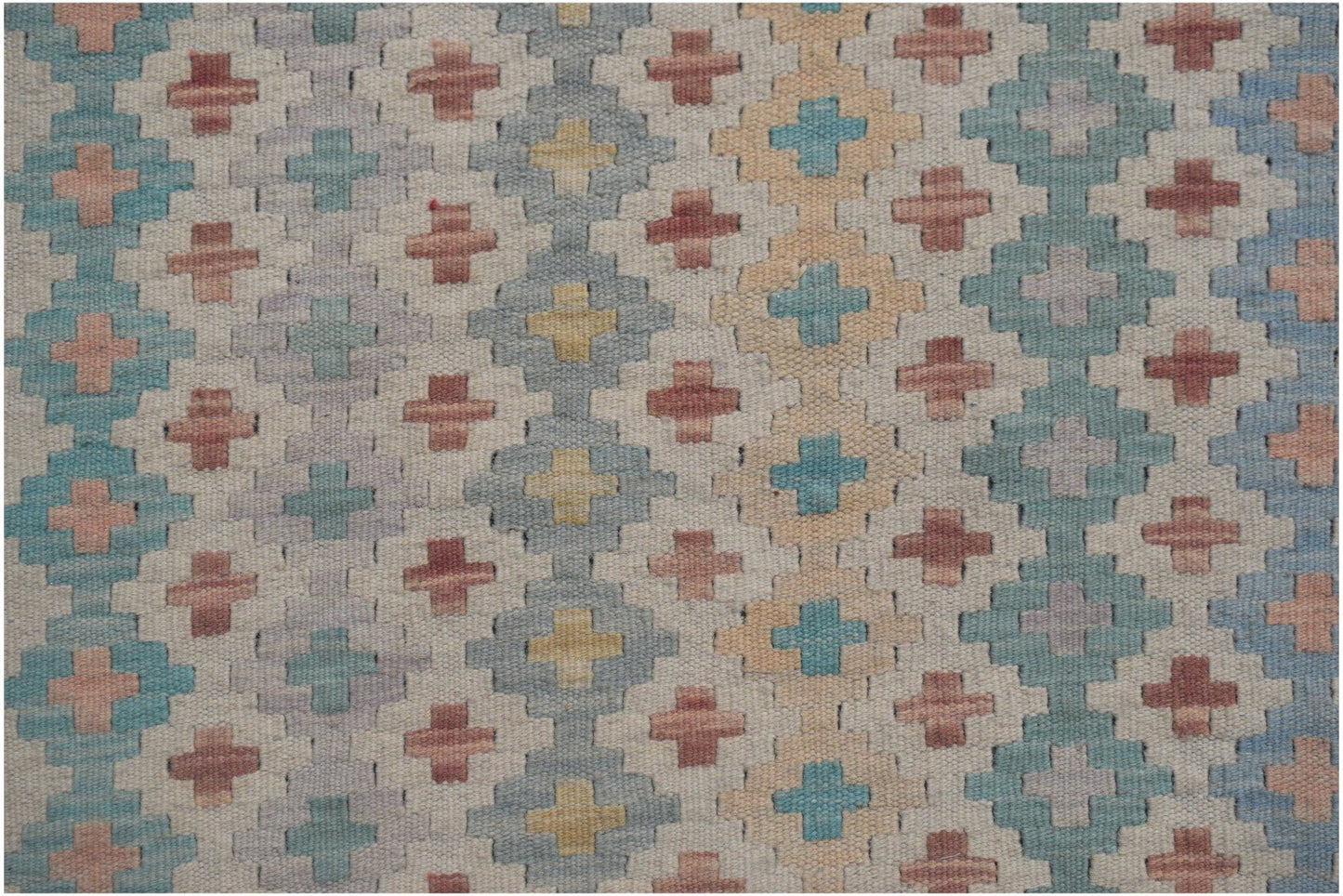 Handmade Afghan Maimana kilim runner featuring a repeating geometric cross pattern in muted tones.