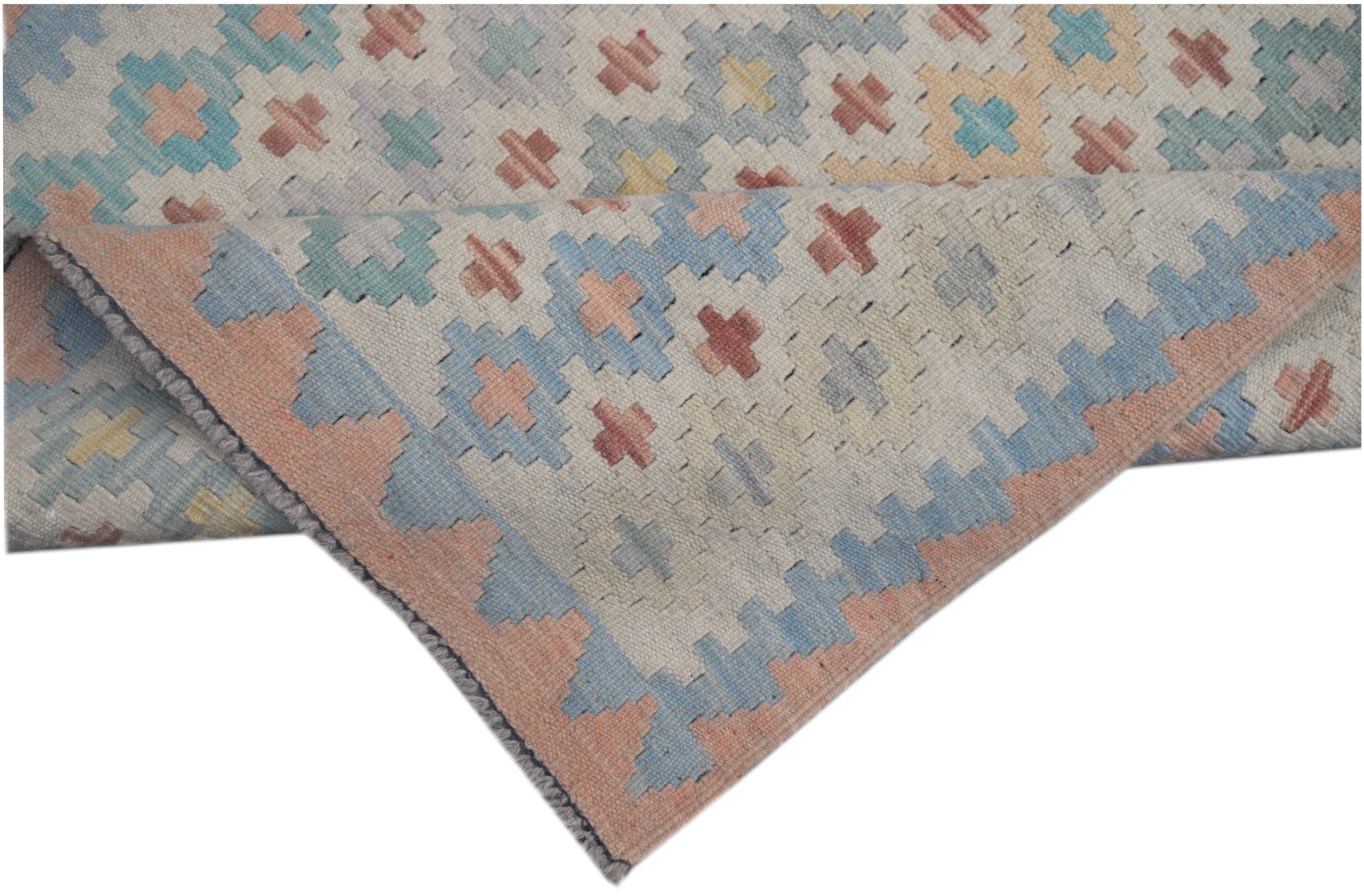 A handmade Afghan Maimana kilim runner featuring a geometric pattern in soft pastel tones.