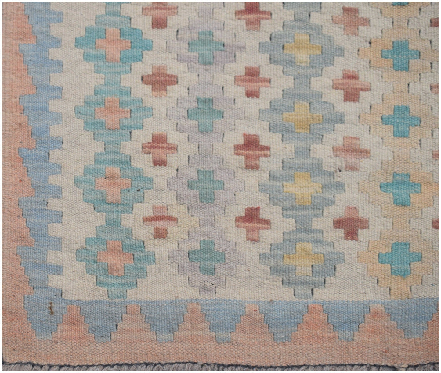 Handmade Afghan Maimana kilim runner featuring a geometric pattern in soft pastel tones.