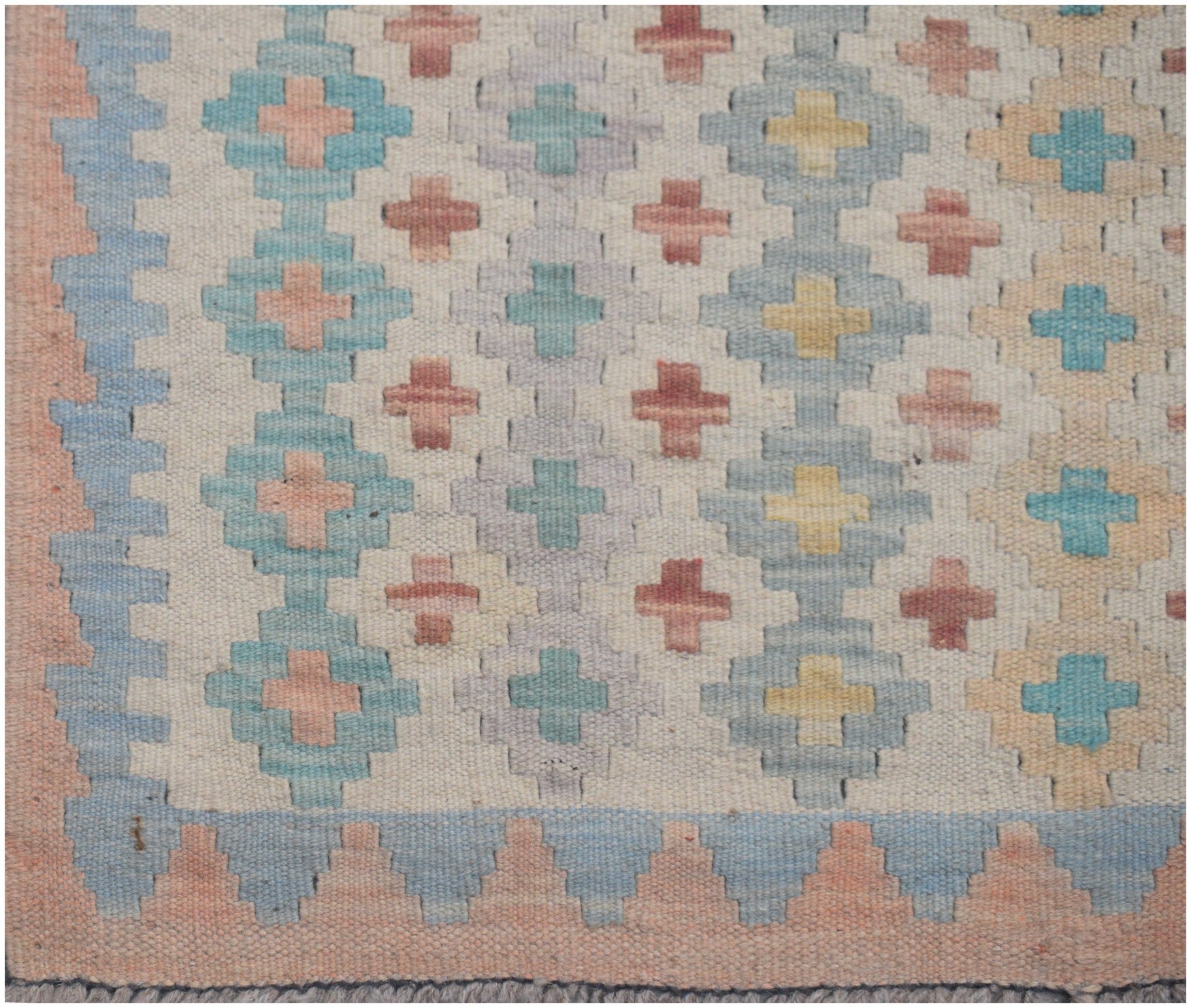 Handmade Afghan Maimana kilim runner featuring a geometric pattern in soft pastel tones.