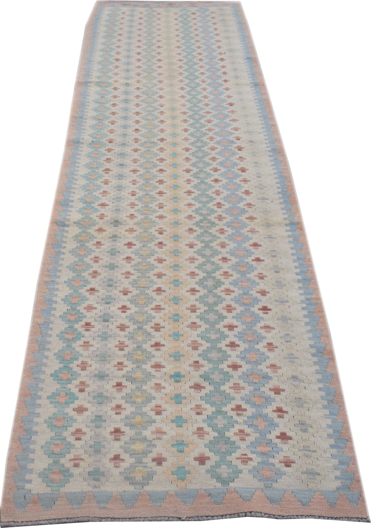 Handmade Afghan Maimana wool runner rug featuring a repeating geometric pattern in pastel colors.