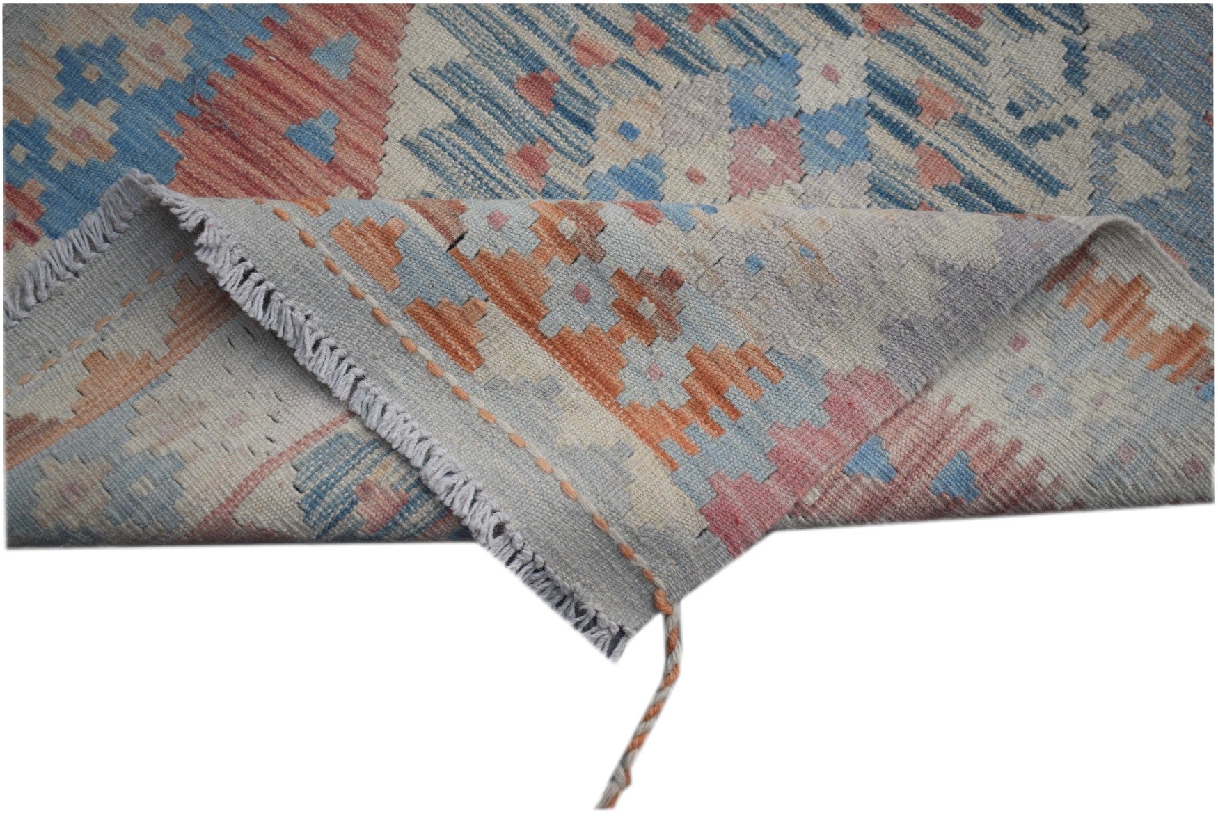 A handmade Afghan Maimana kilim runner featuring geometric patterns in blue, orange, and pink.