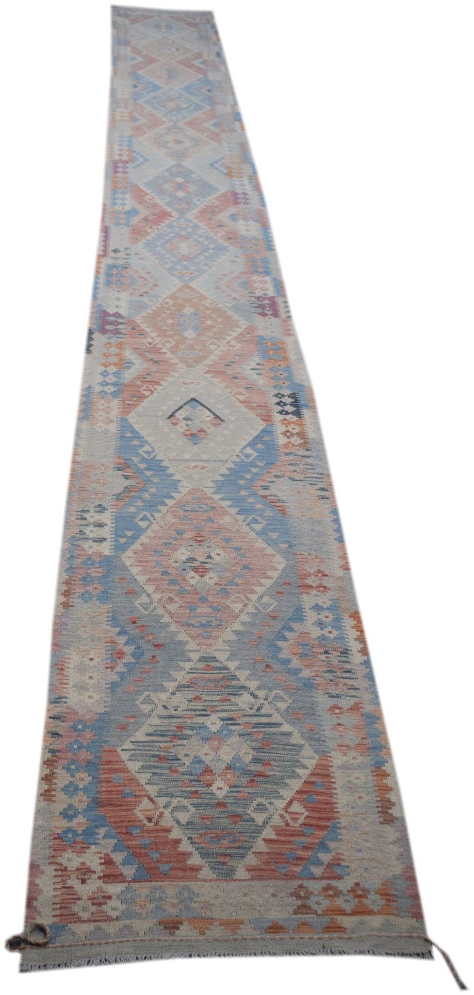 Handmade Afghan Maimana wool runner rug featuring a geometric diamond pattern in muted colors.