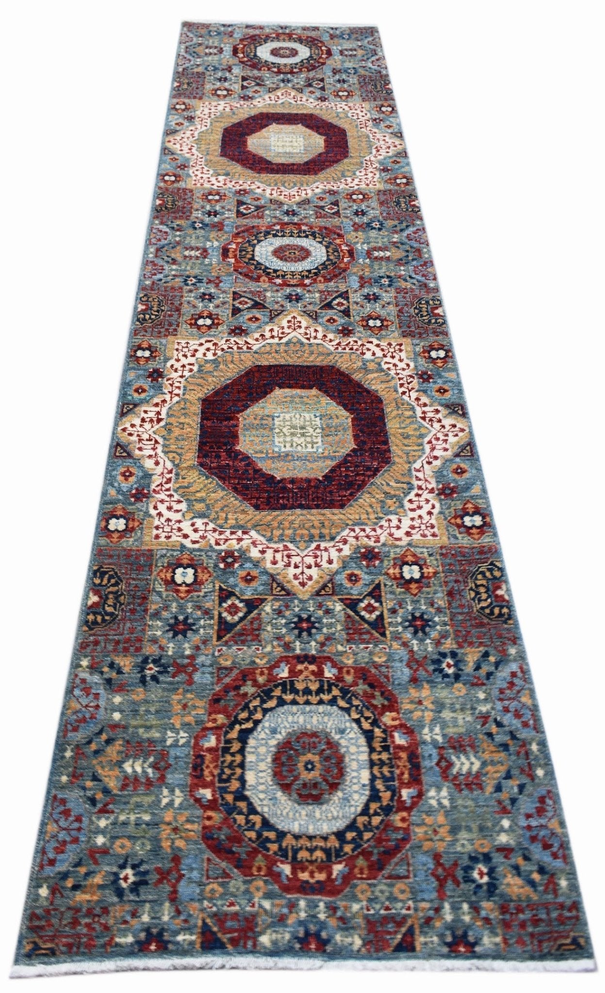 A handmade Afghan Chobi runner rug featuring a traditional Mamluk medallion pattern in blue tones.