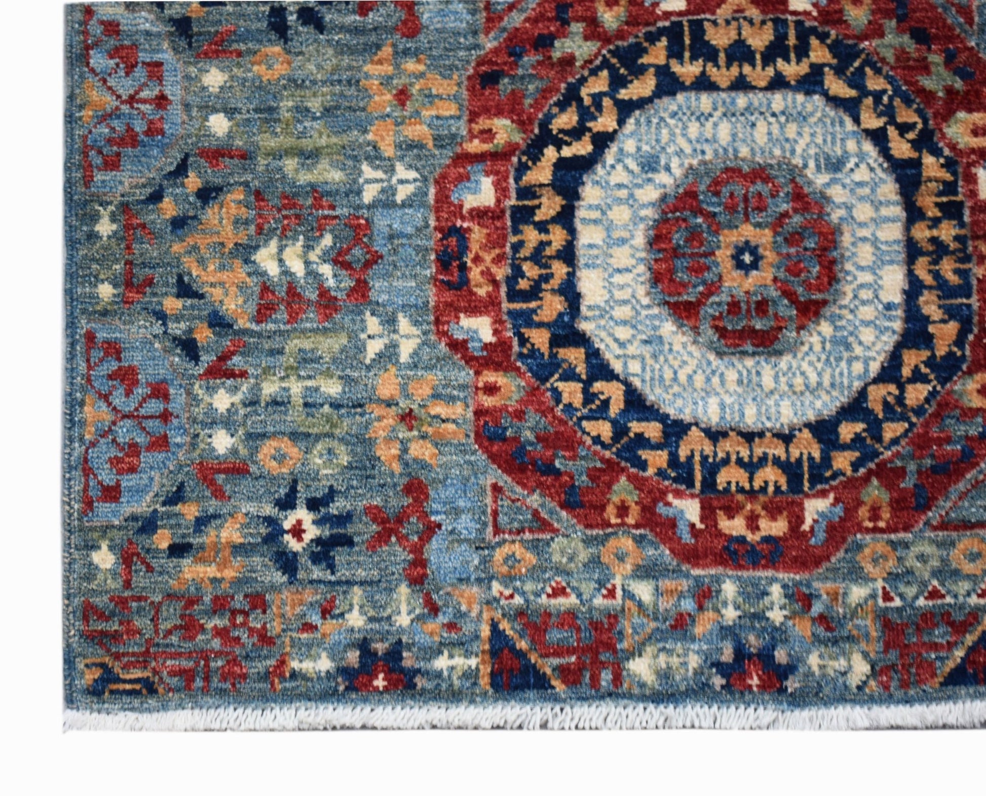 A handmade Afghan Chobi runner featuring a detailed Mamluk medallion pattern in blue and red.