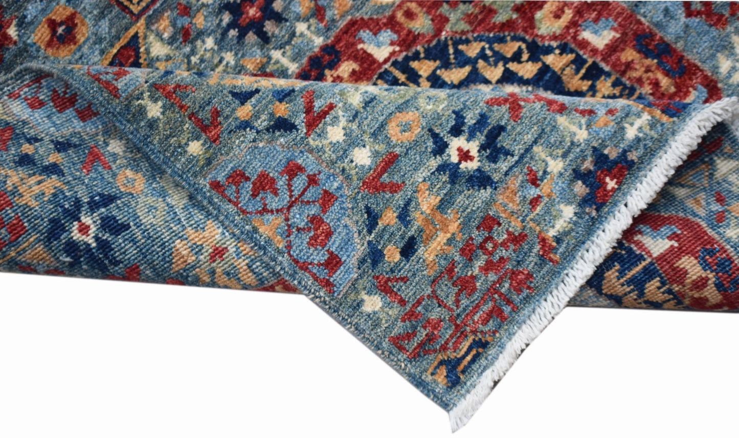 A handwoven Afghan Chobi runner featuring a traditional blue Mamluk pattern with red accents.