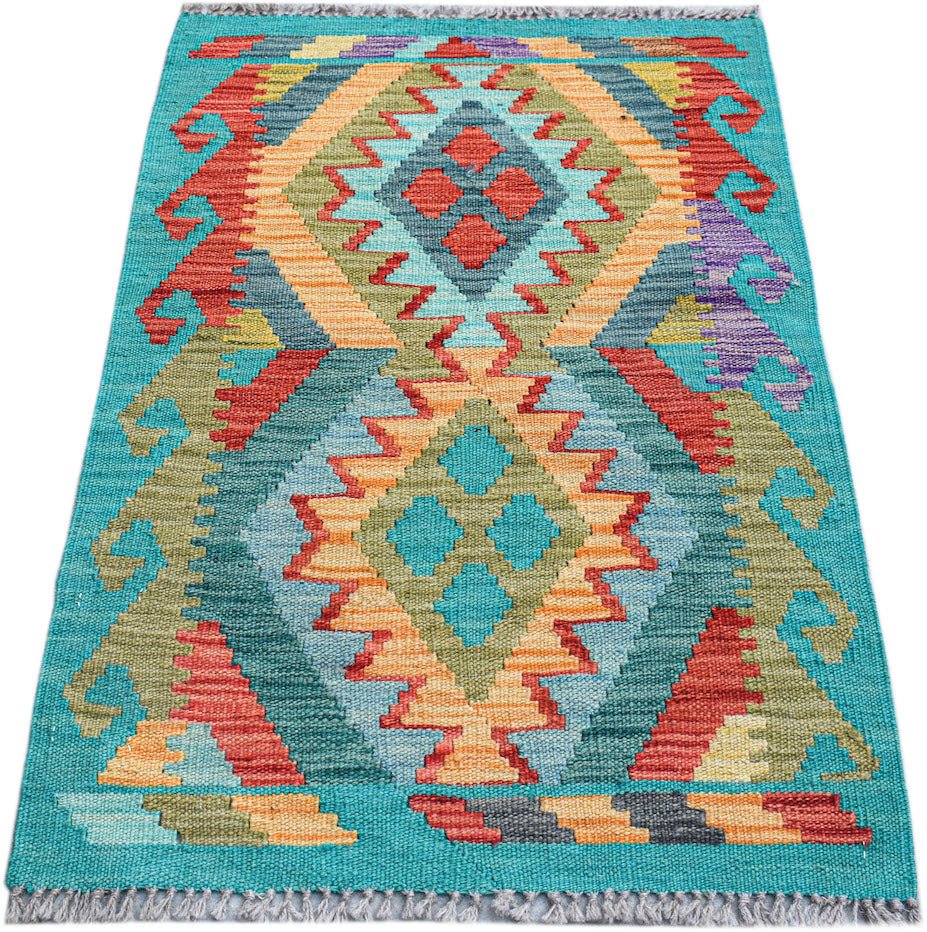 A rectangular handmade Afghan Maimana kilim featuring a vibrant geometric pattern in wool.