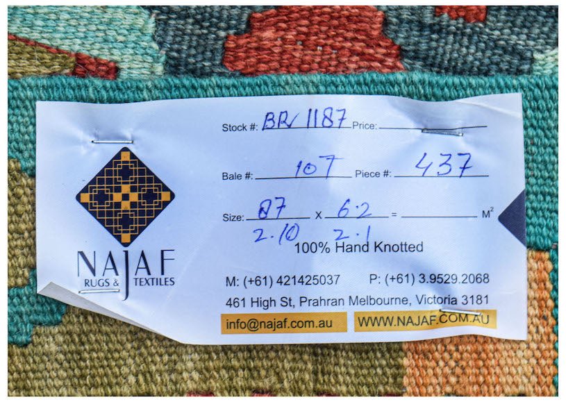 A handwoven Afghan Maimana kilim featuring a colorful geometric pattern and flatweave texture.