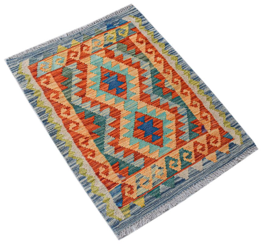 A rectangular handmade Afghan Maimana kilim featuring a geometric pattern in blue, orange, and tan.