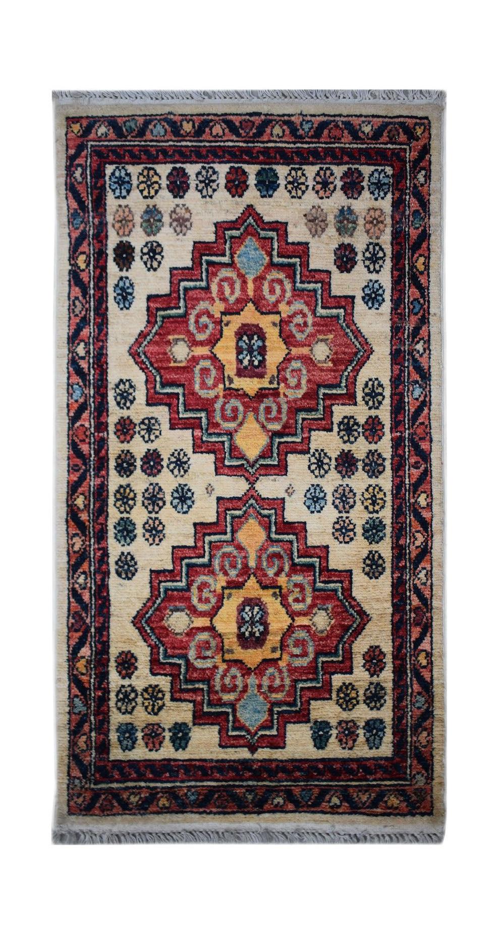 A handmade Afghan Chobi rug featuring two geometric medallions on a cream field with floral motifs.