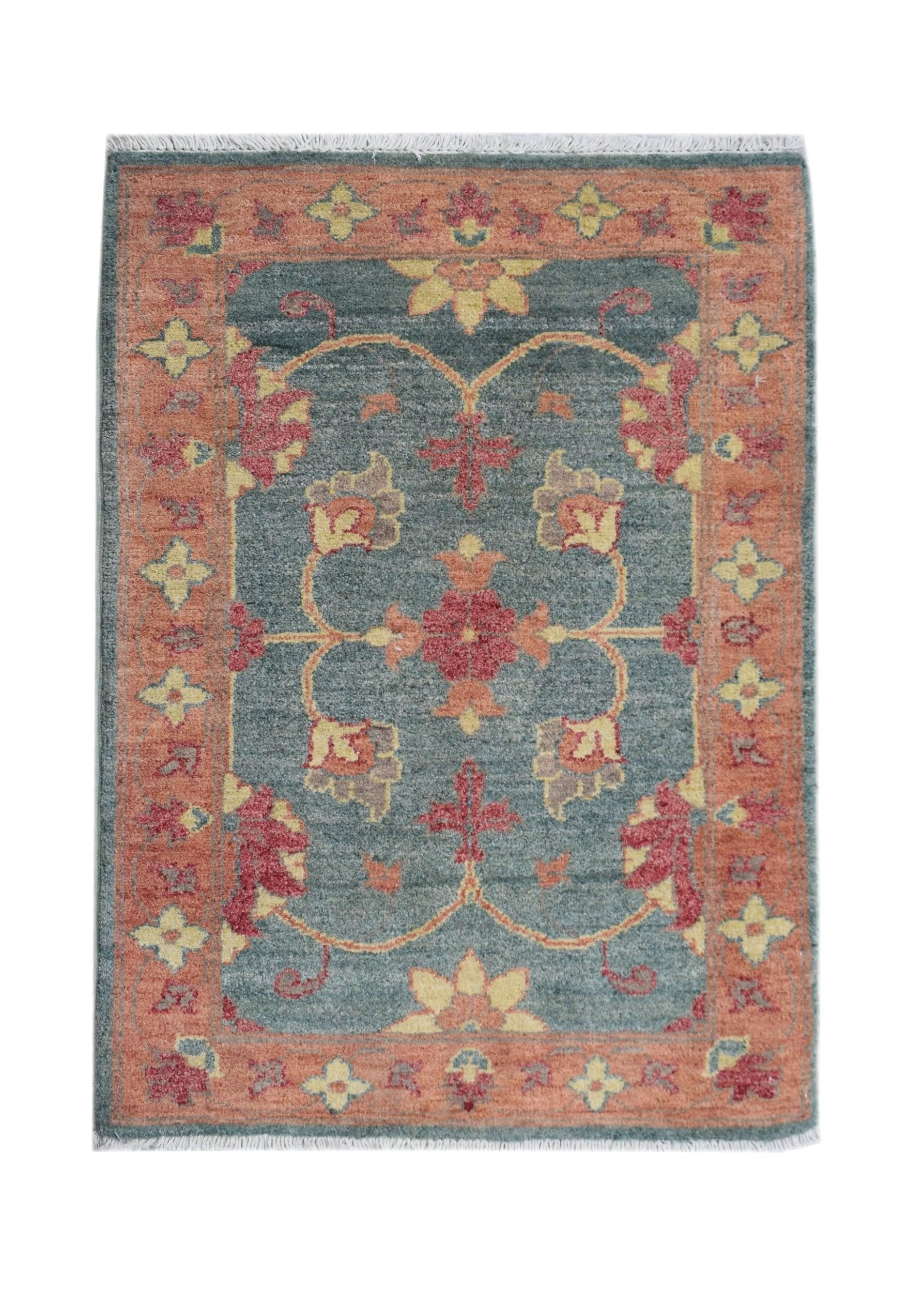 A handmade wool Afghan Chobi rug featuring a floral pattern in blue, red, and yellow tones.