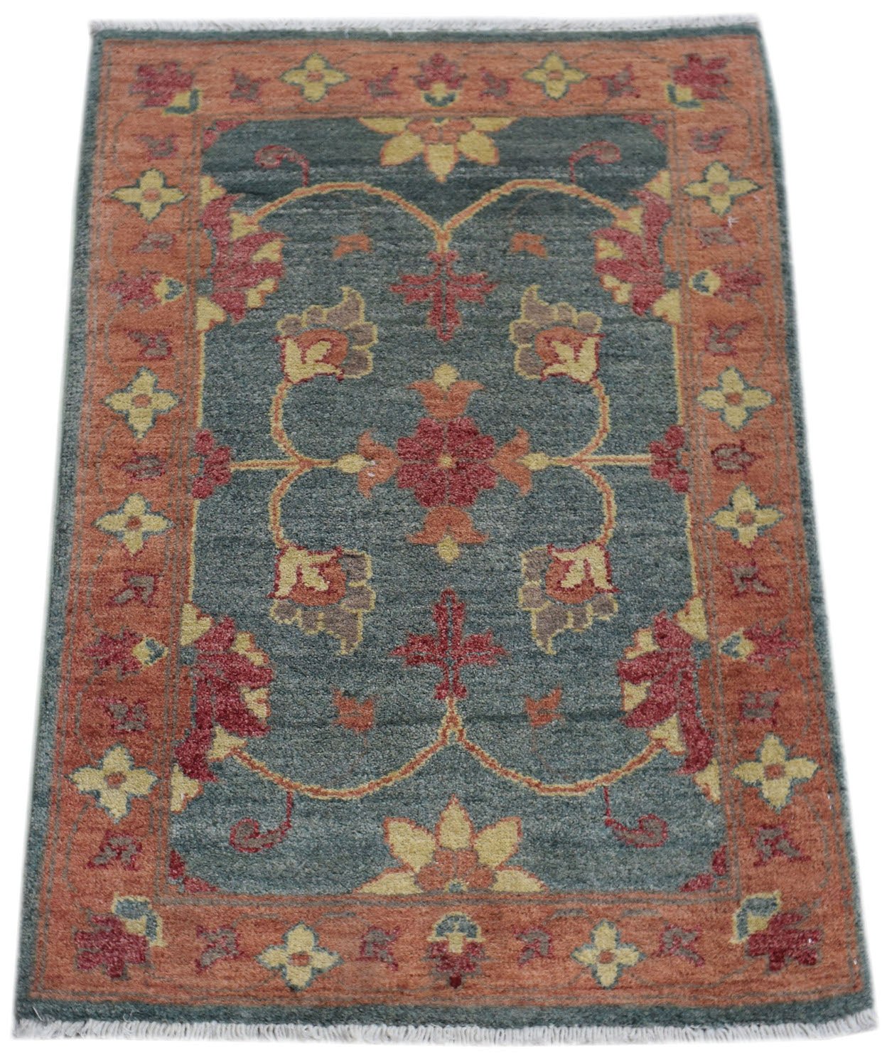 A handmade wool Afghan Chobi rug featuring a floral pattern in red and yellow on a blue background.