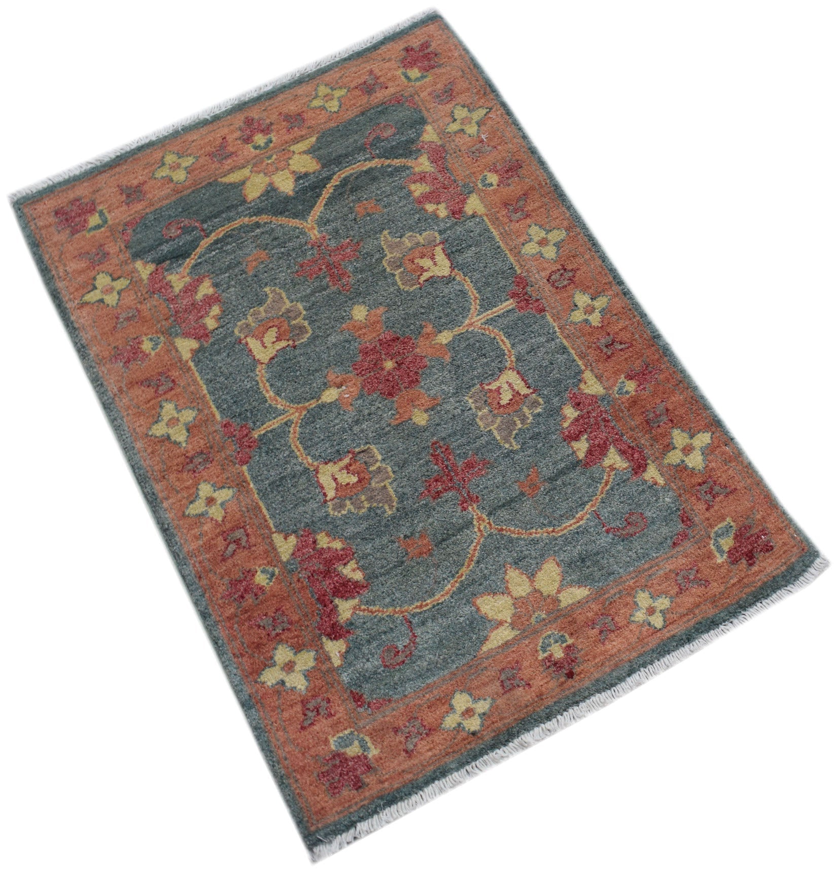 A handmade Afghan Chobi rug featuring a floral pattern in red, yellow, and blue-grey wool.