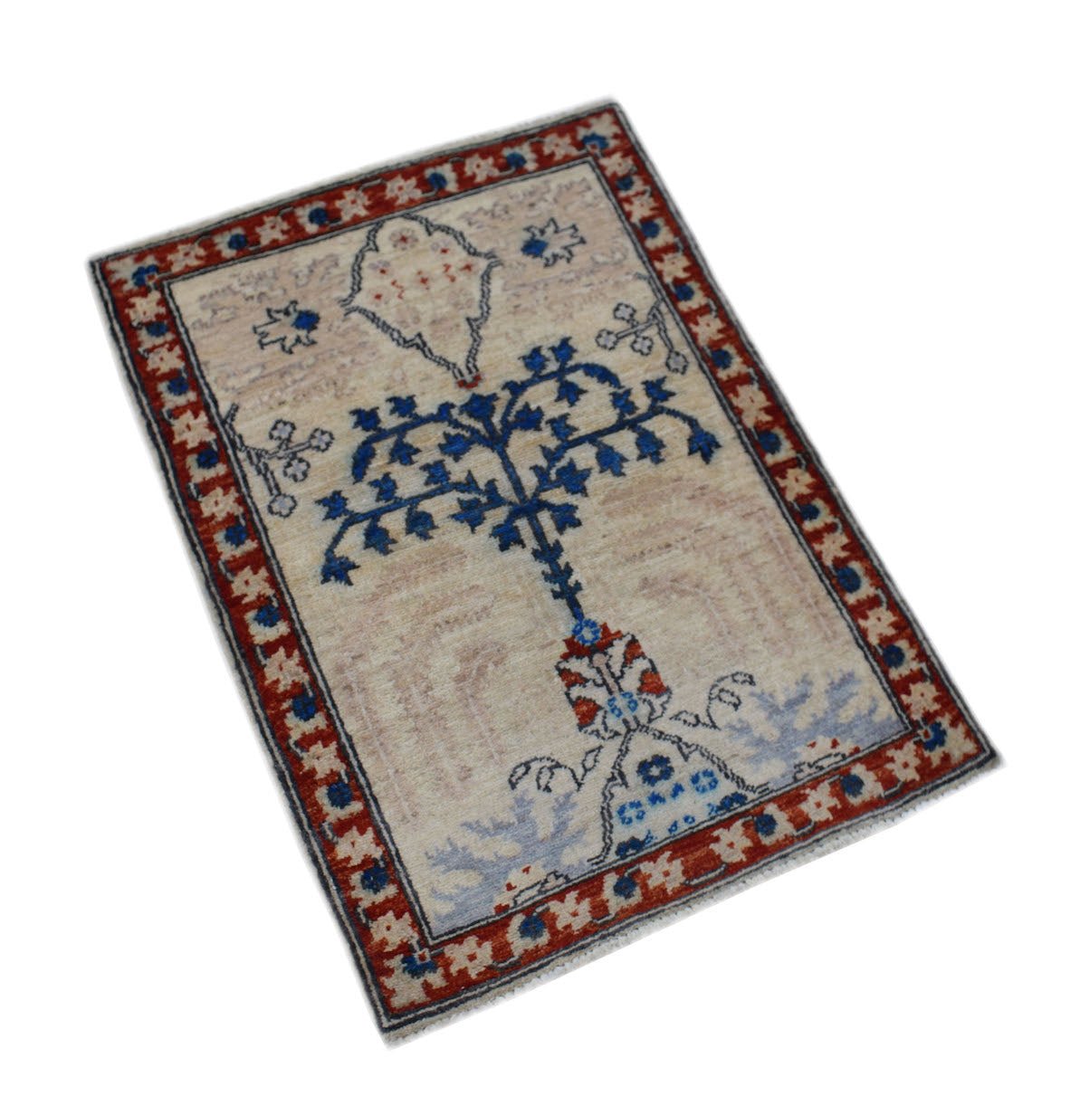 A handmade Afghan Chobi rug featuring a central blue tree motif on a light beige field.