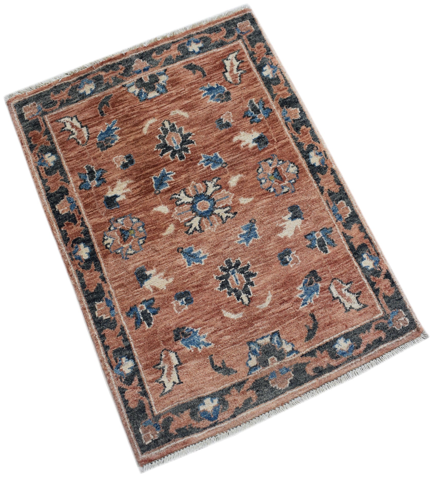 A handmade Afghan Chobi rug featuring a terracotta field with blue and cream floral motifs.