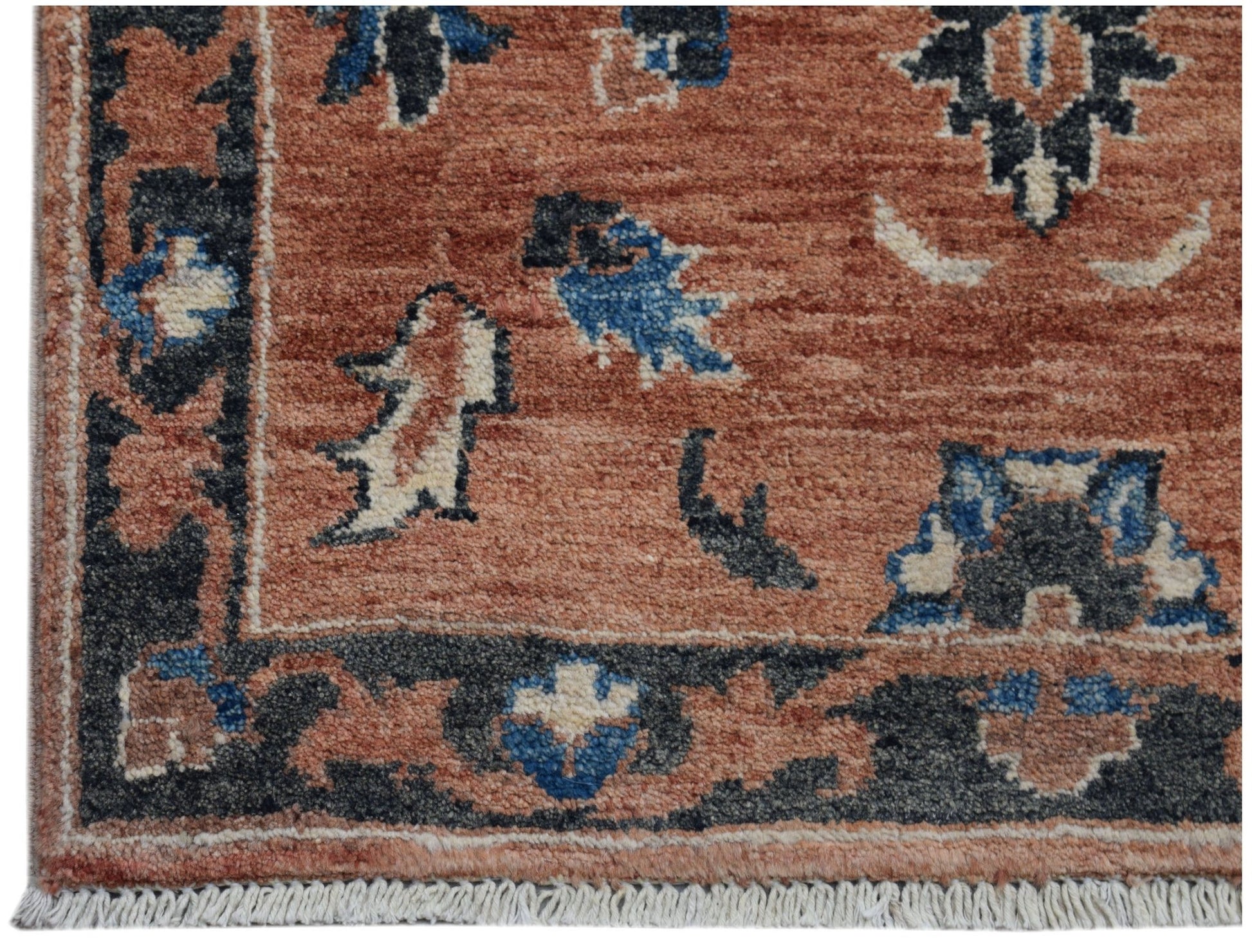 A handmade Afghan Chobi rug featuring a terracotta field with blue and cream floral motifs.