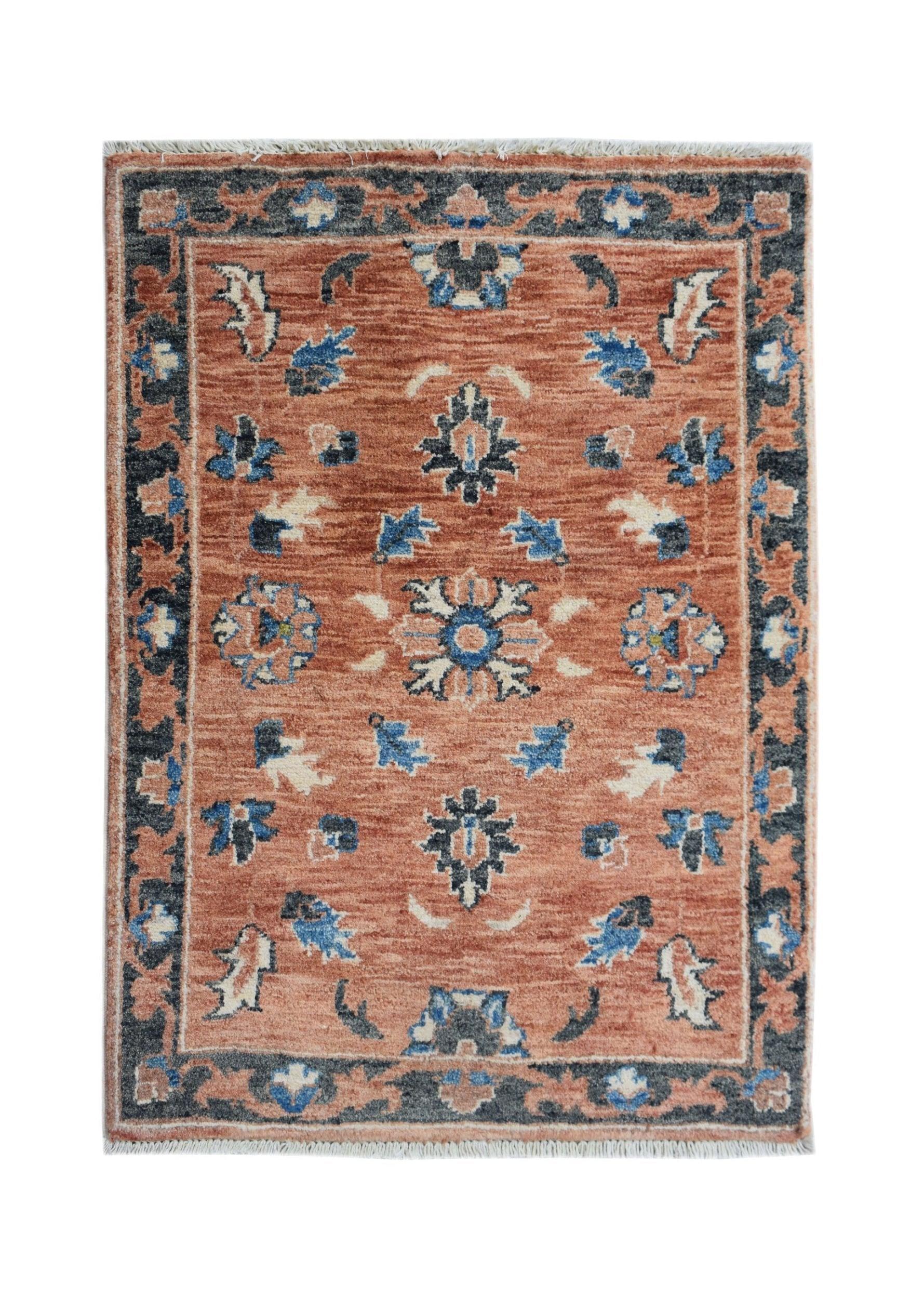 Handmade Afghan Chobi rug featuring a floral pattern in rust, blue, and cream tones.