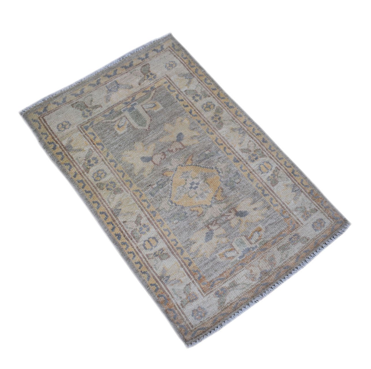 A handmade mini Afghan Chobi rug featuring a traditional geometric pattern in muted earth tones.