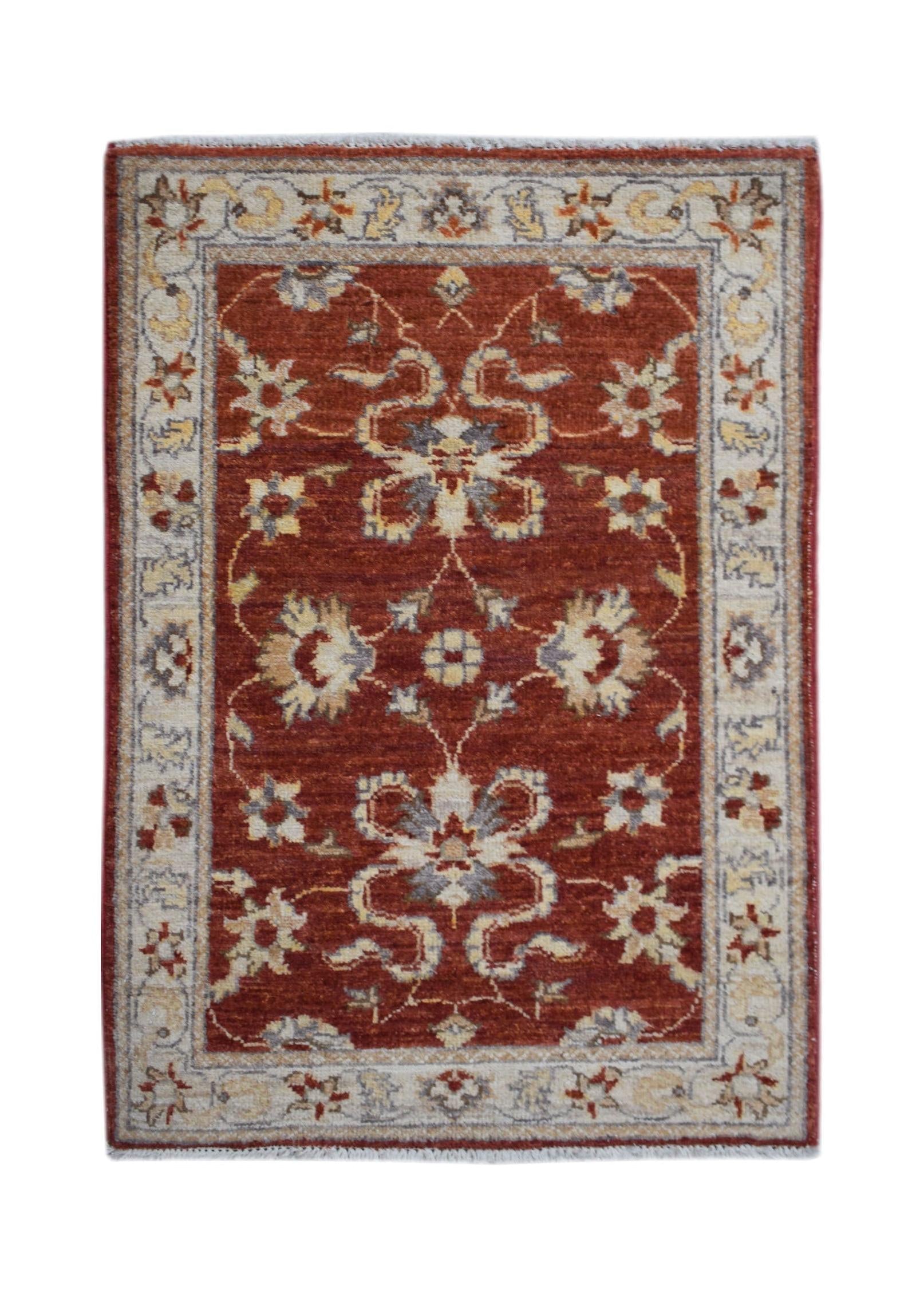 A rectangular handmade Afghan Chobi rug featuring a floral pattern in rust red and cream tones.