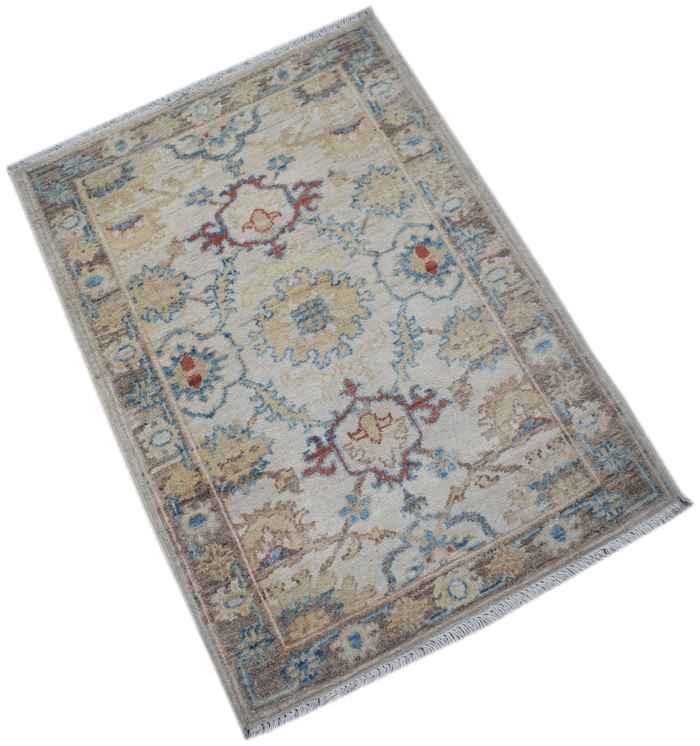 A handmade Afghan Chobi rug featuring a traditional floral pattern in blue, red, and beige tones.