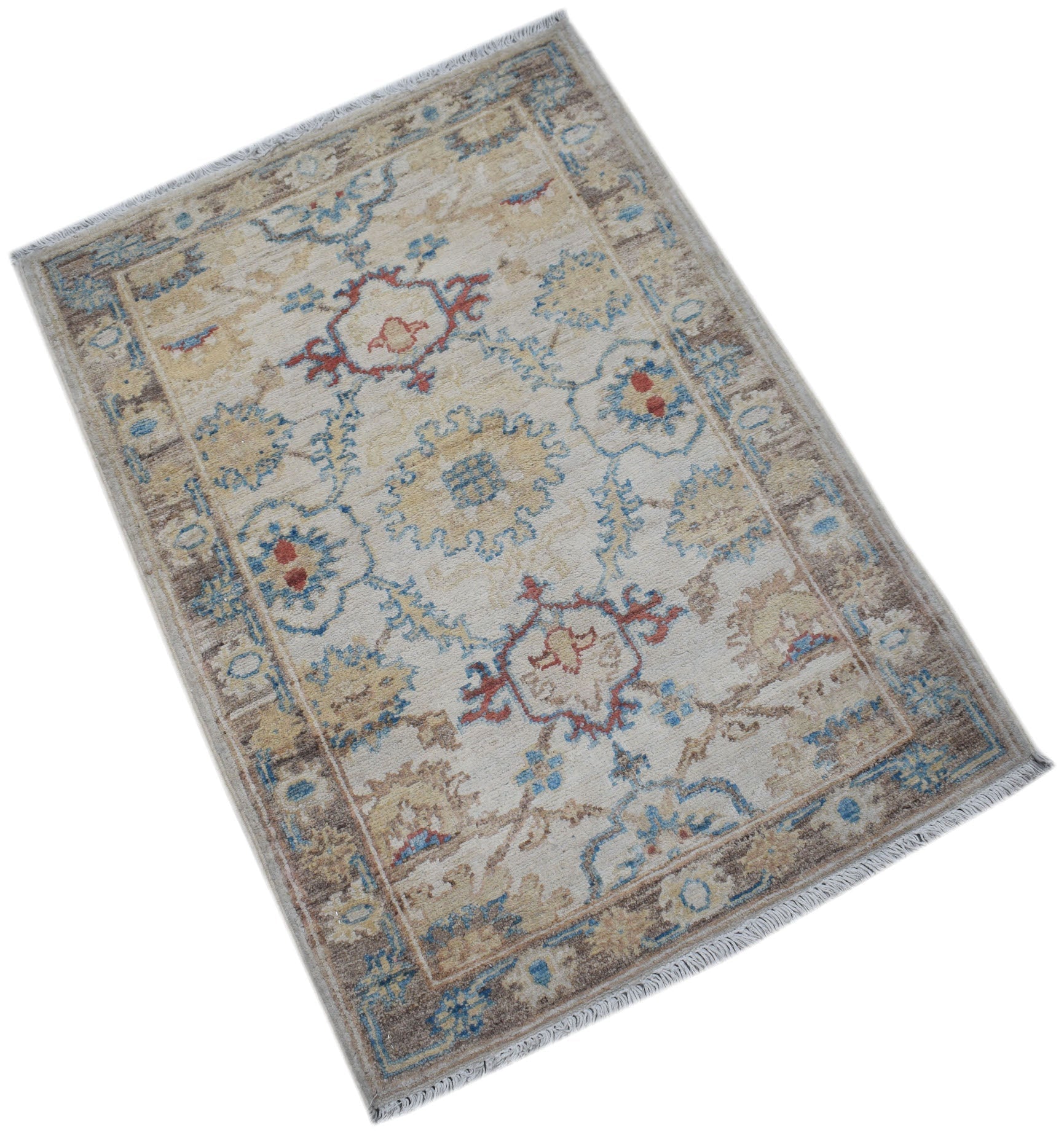 A handmade Afghan Chobi rug featuring a traditional floral pattern in blue, red, and beige tones.