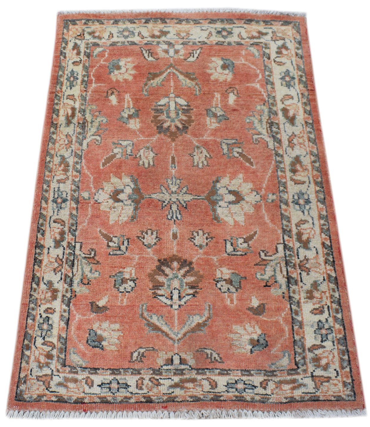 A handmade Afghan Chobi rug featuring a floral pattern in shades of terracotta, cream, and blue.