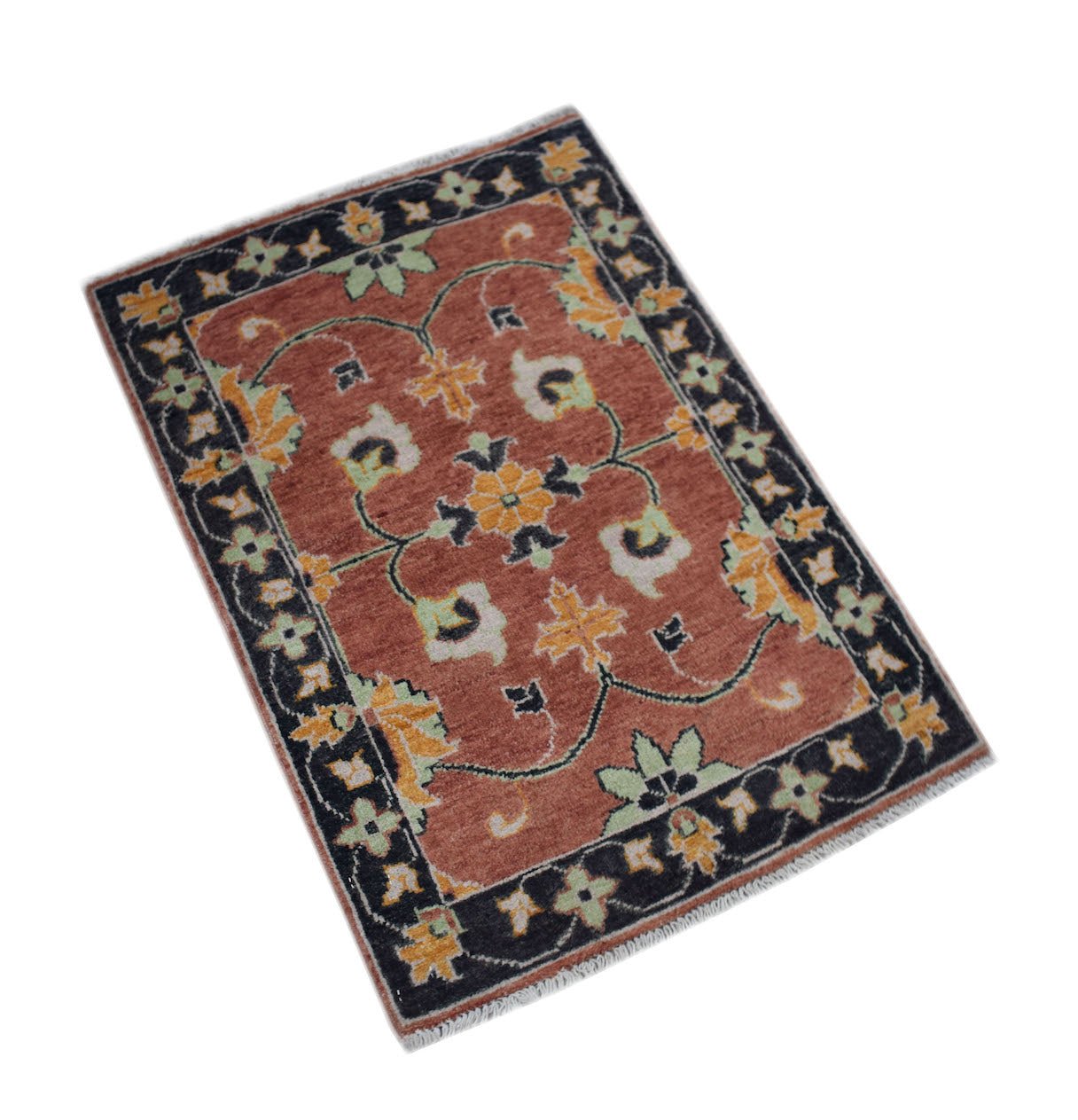 A rectangular handmade Afghan Chobi rug featuring a floral pattern in rust, yellow, and green.