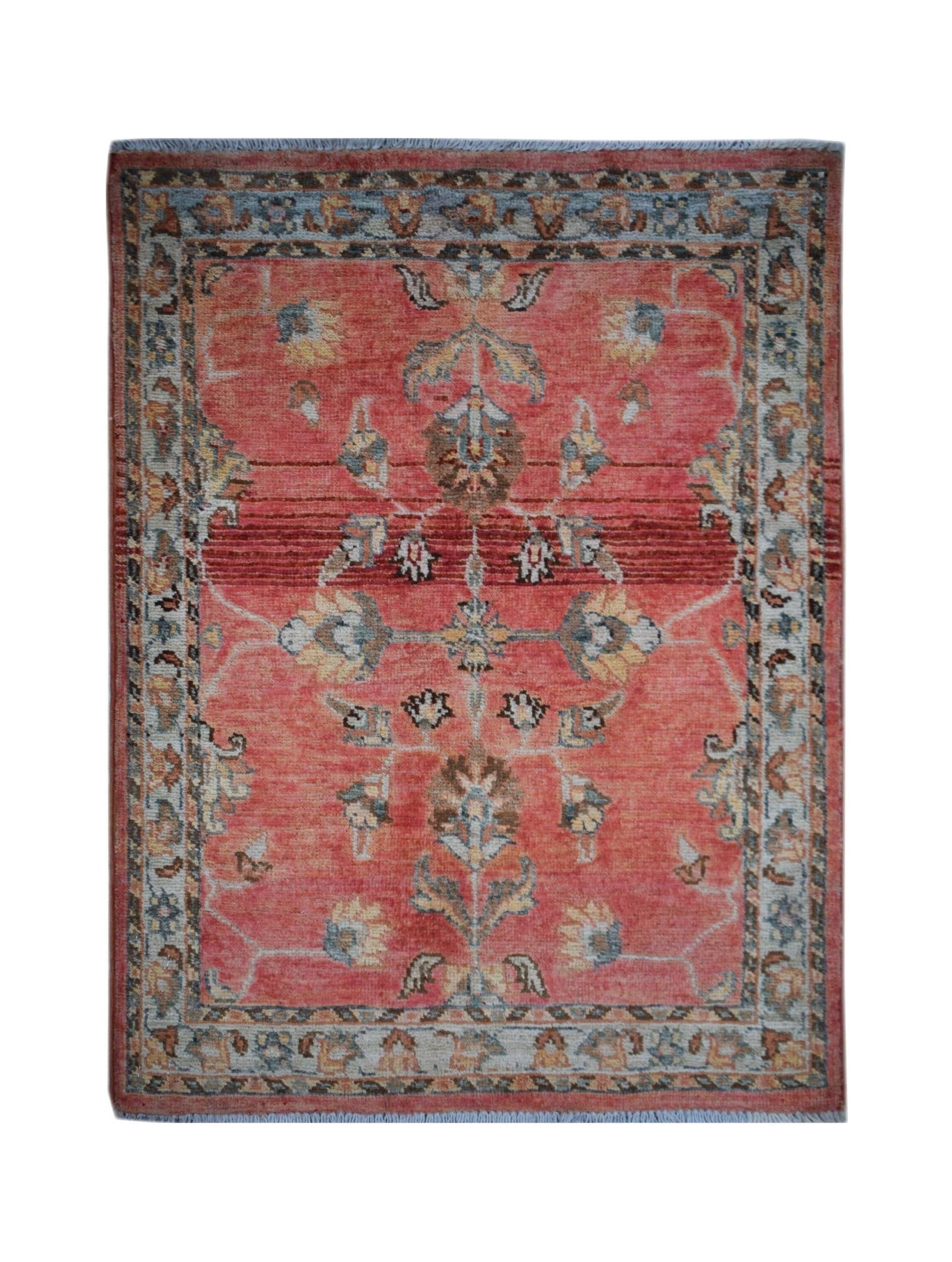 A handmade Afghan Chobi rug featuring a floral pattern in shades of red, blue, and beige.