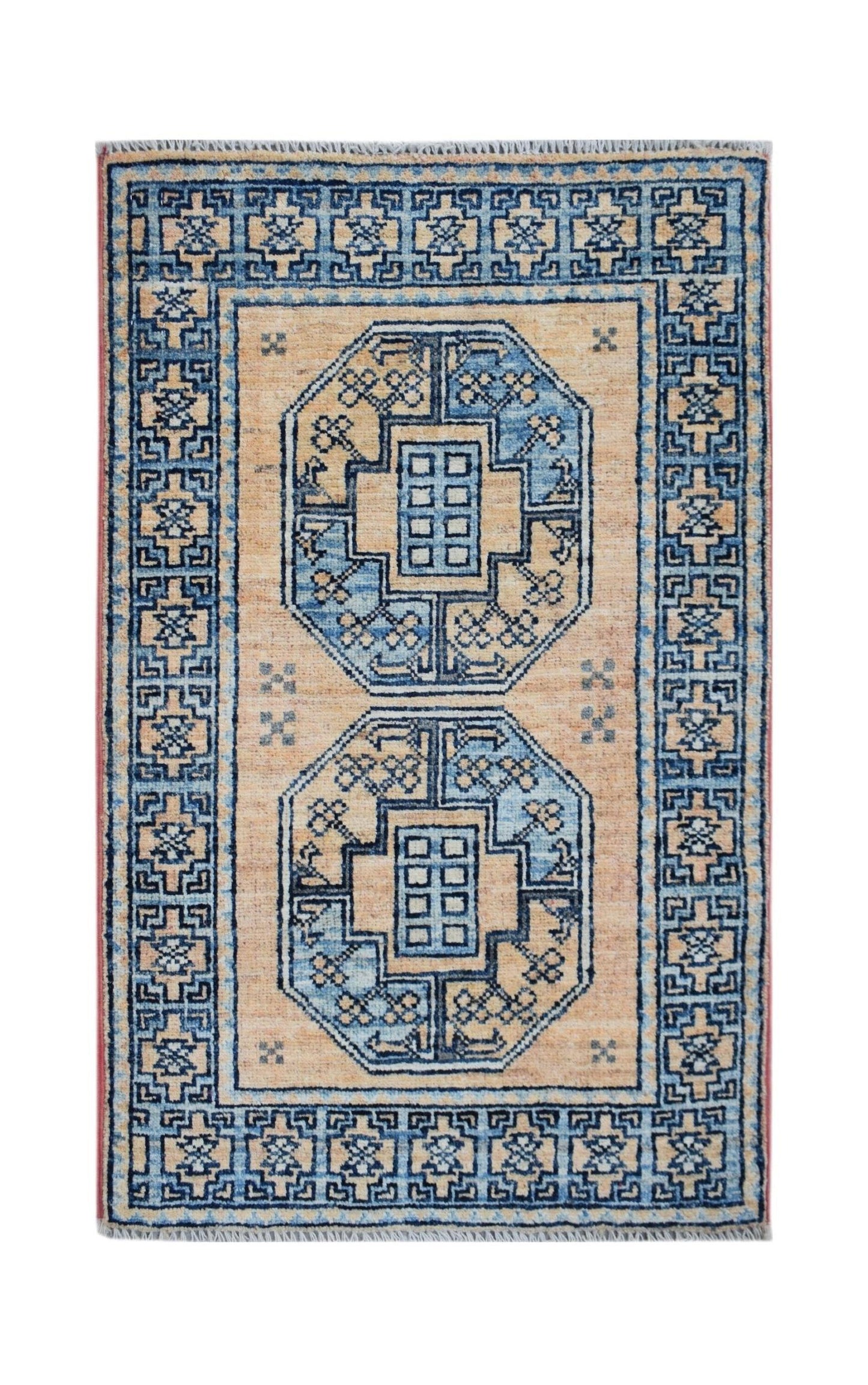 A handmade Afghan Chobi rug featuring two blue octagonal medallions on a tan field.