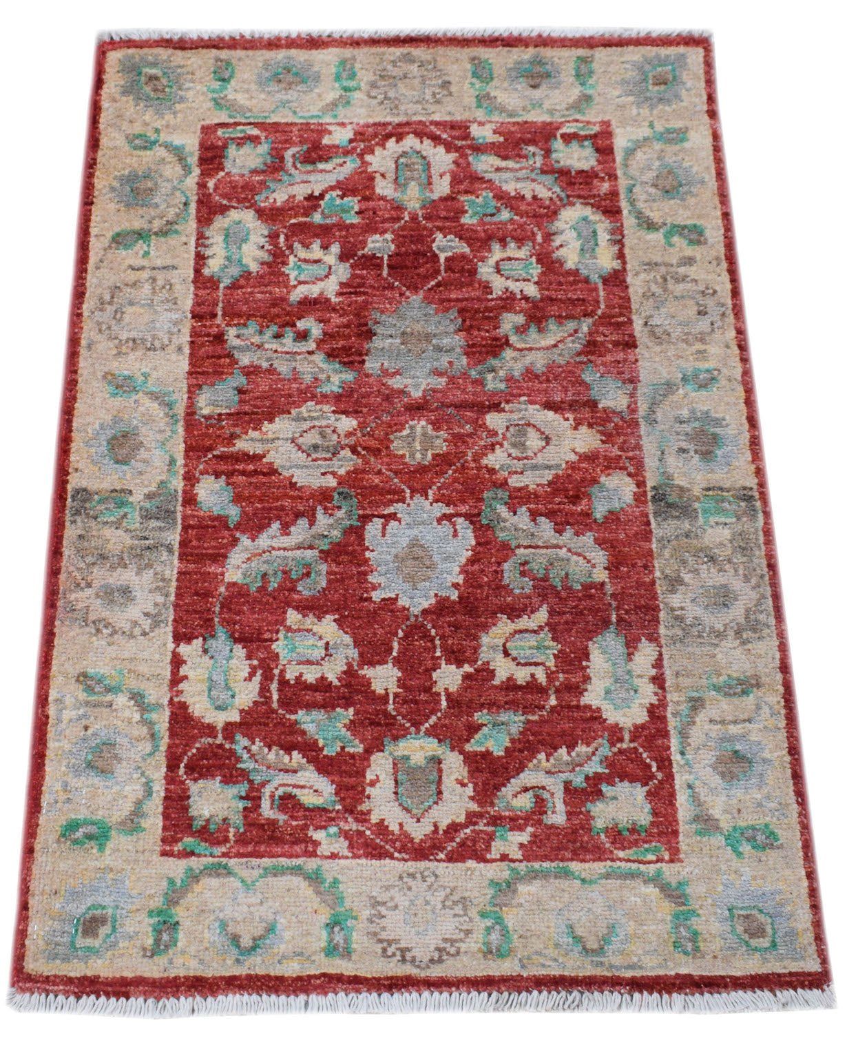 A handmade Afghan Chobi rug featuring a red field with floral patterns and a beige border.