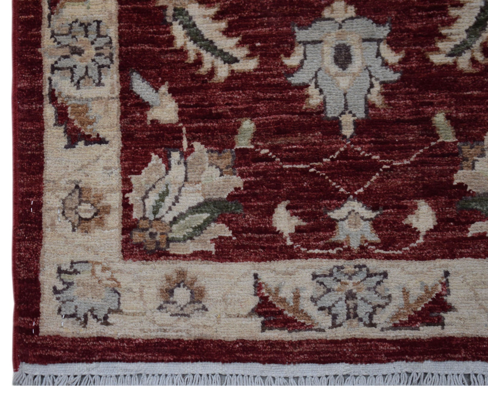 A handmade Afghan Chobi rug featuring a traditional floral pattern in deep red and cream tones.