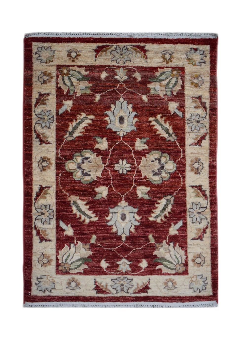 A handmade mini Afghan Chobi rug featuring a floral pattern in red, cream, and soft blue tones.