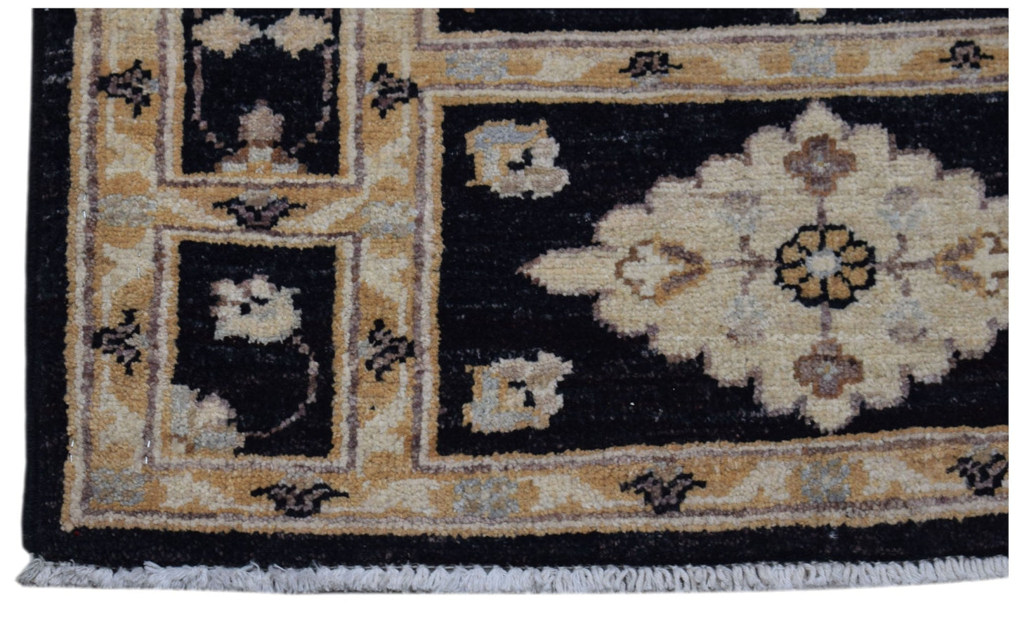 A handmade Afghan Chobi rug featuring a black field with a central cream floral medallion.