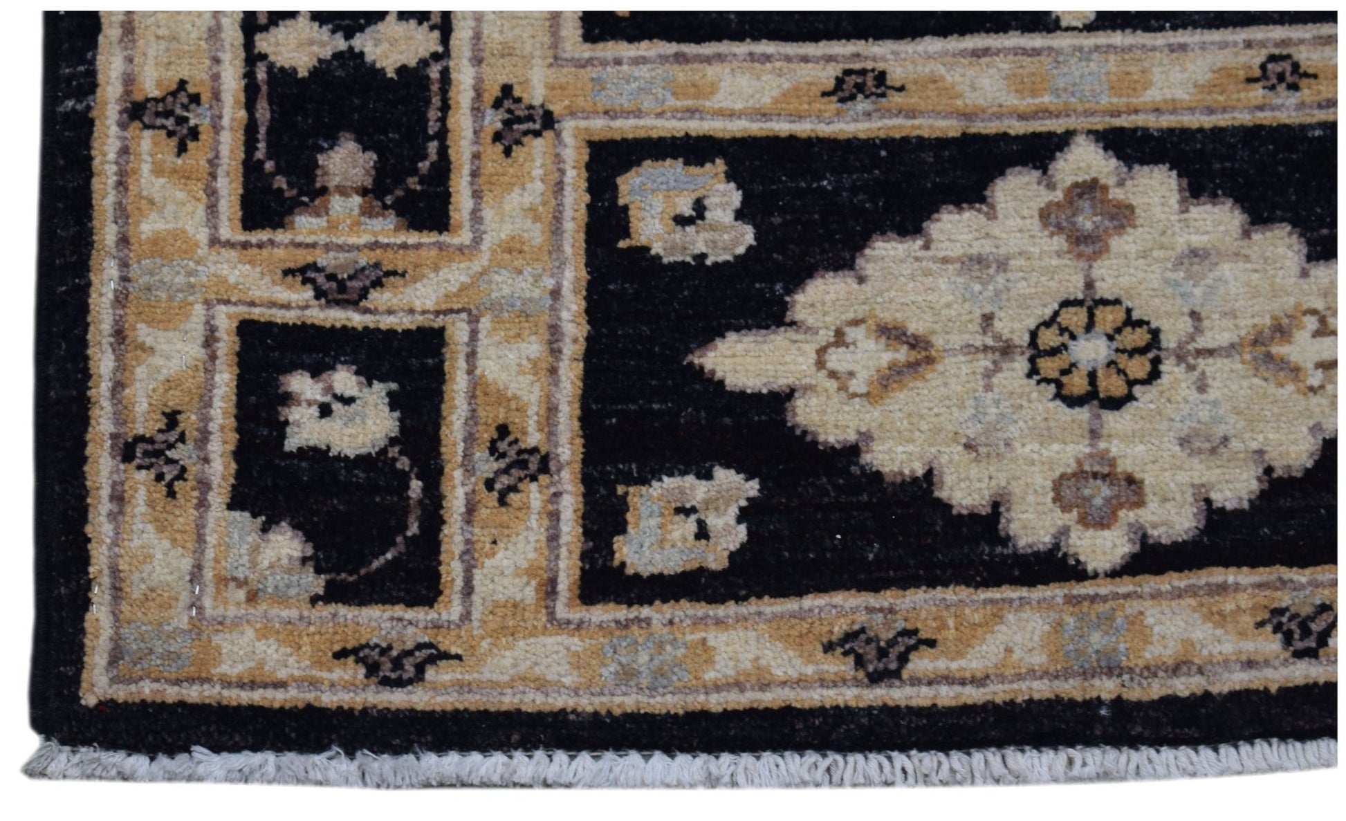 A handmade Afghan Chobi rug featuring a black field with a central cream floral medallion.