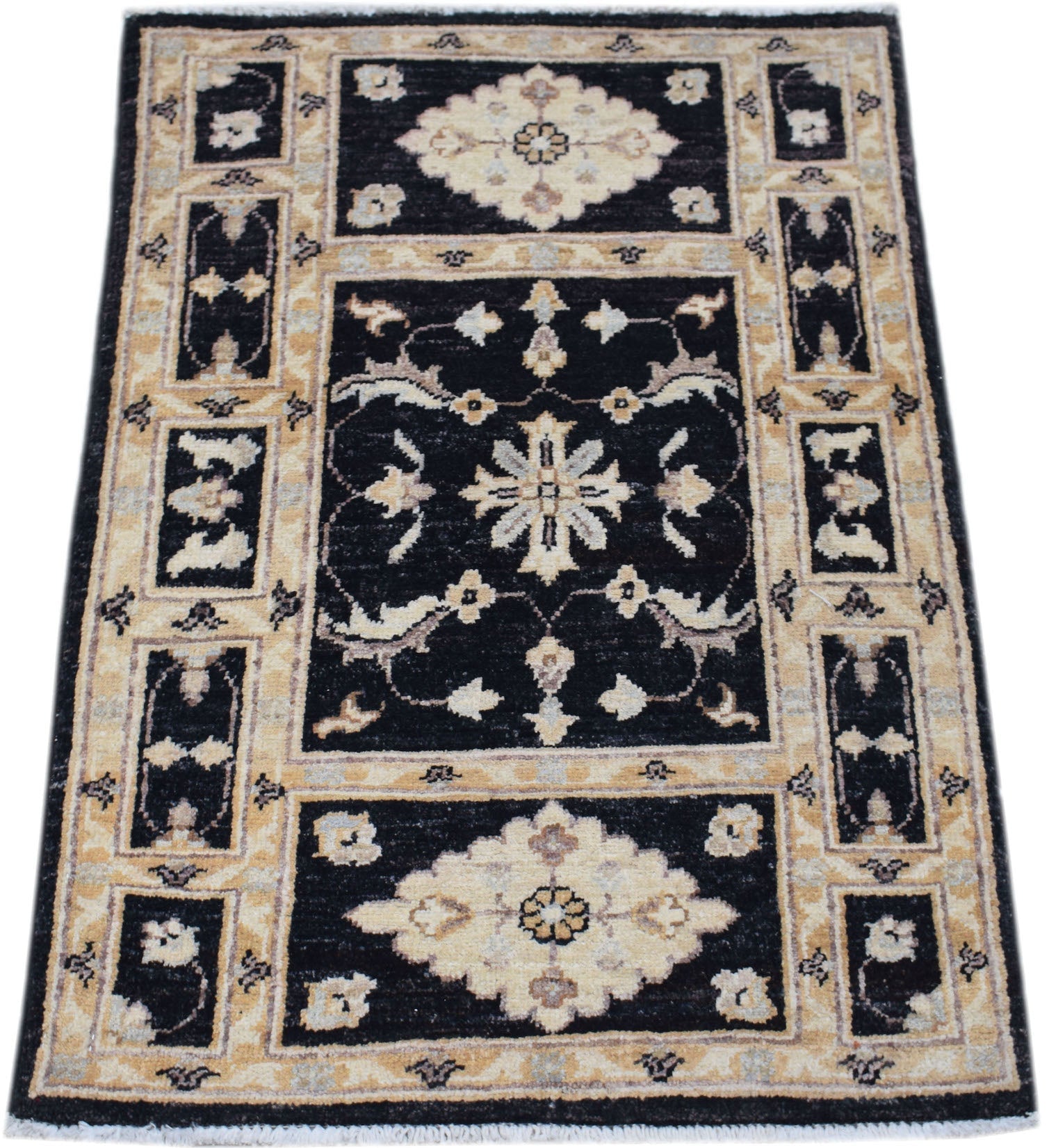 A rectangular handmade Afghan Chobi rug featuring a black field with cream floral motifs.