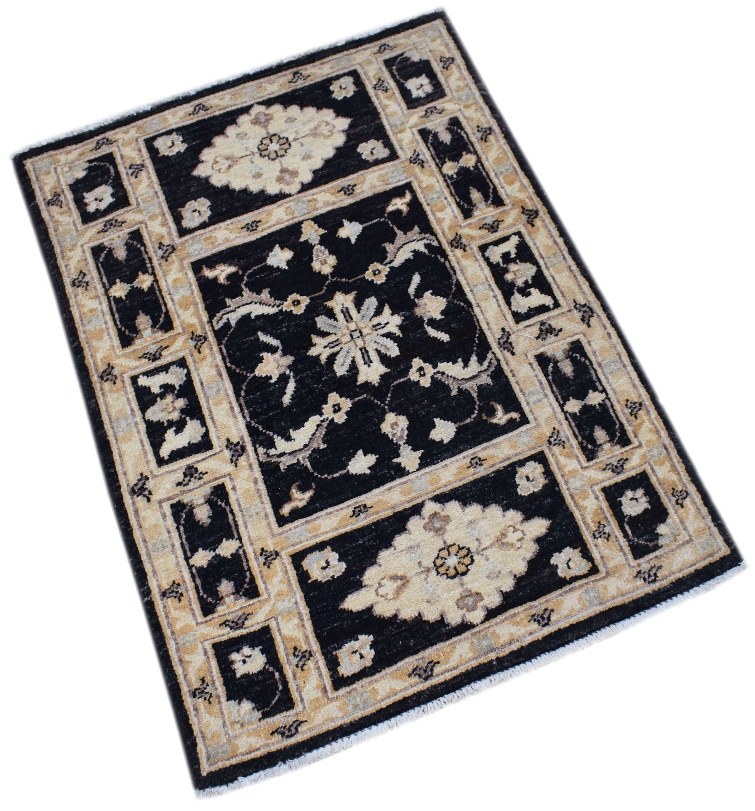 A rectangular handmade Afghan Chobi rug featuring a black field with beige floral motifs.