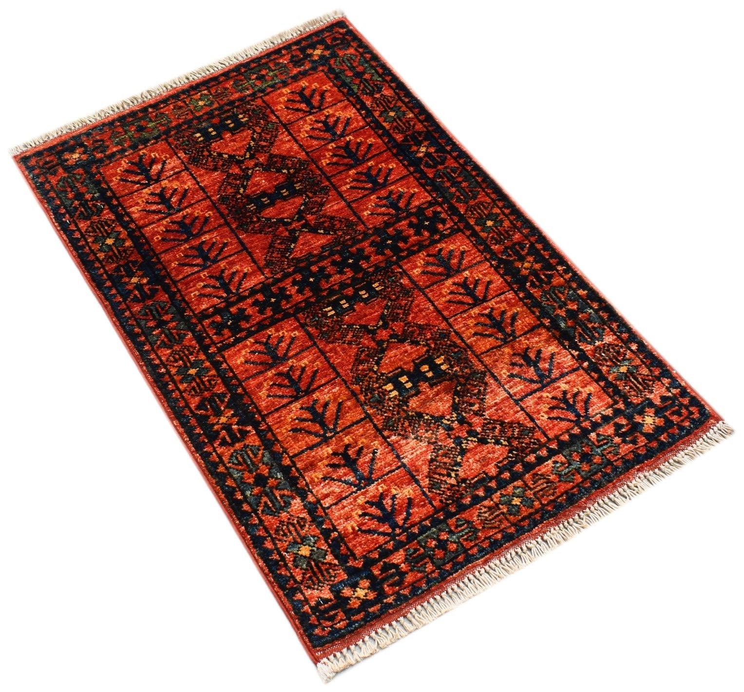 A handmade mini Afghan Chobi rug featuring a traditional geometric pattern in red and dark blue.