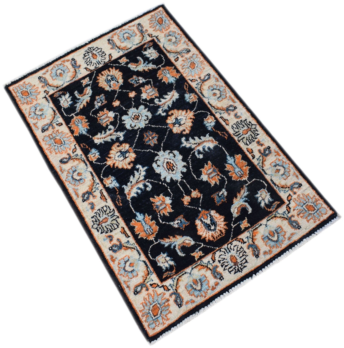 A handmade Afghan Chobi rug featuring a dark blue field with floral patterns in orange and cream.