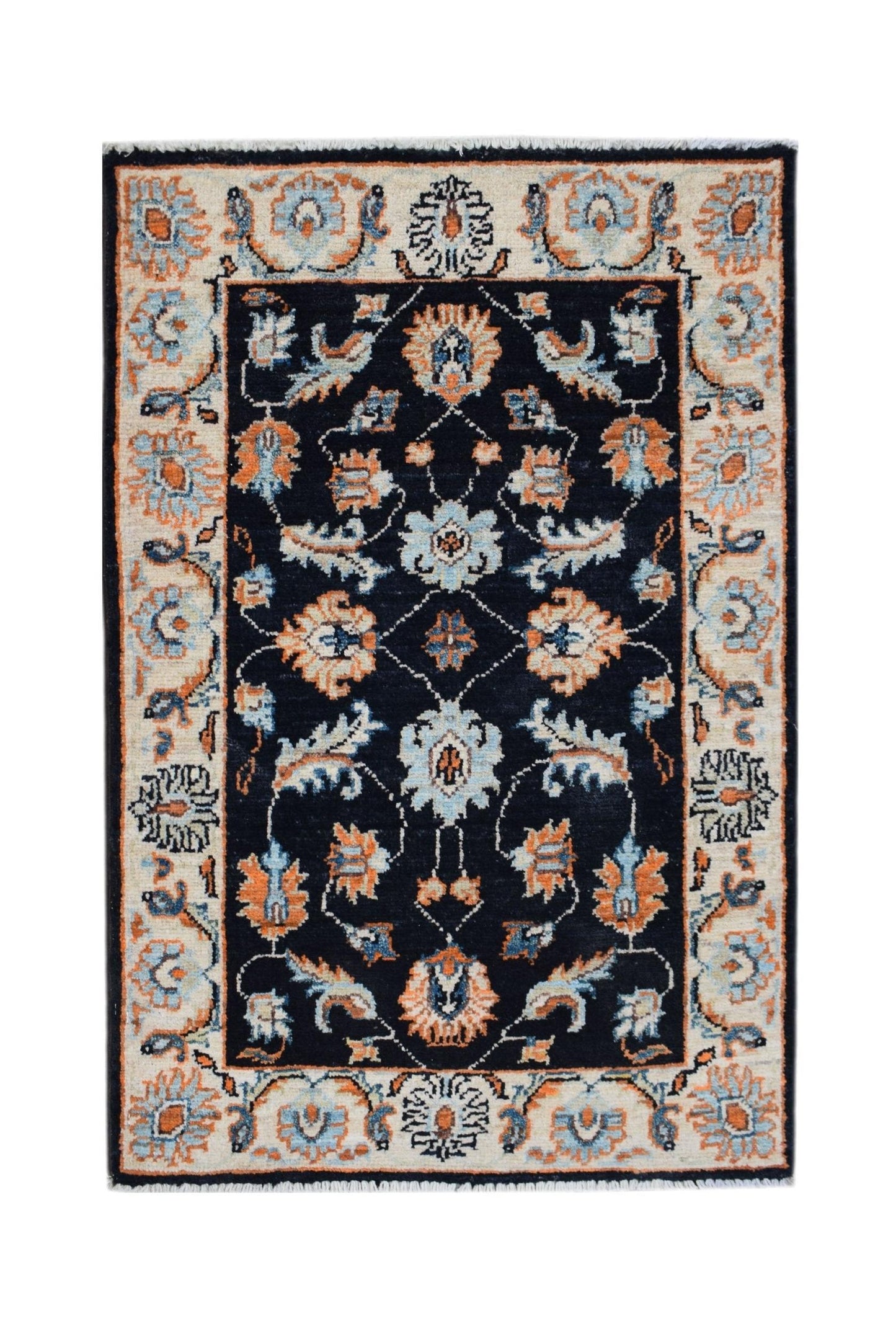 A handmade Afghan Chobi rug featuring a dark blue field with intricate floral patterns in orange.