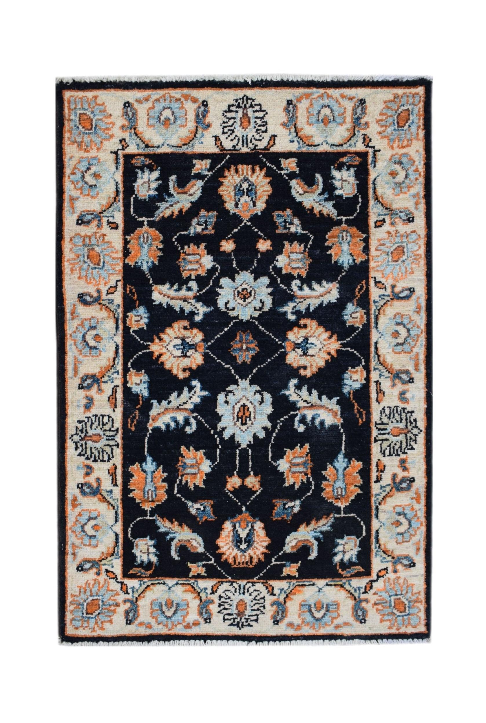 A handmade Afghan Chobi rug featuring a dark blue field with intricate floral patterns in orange.