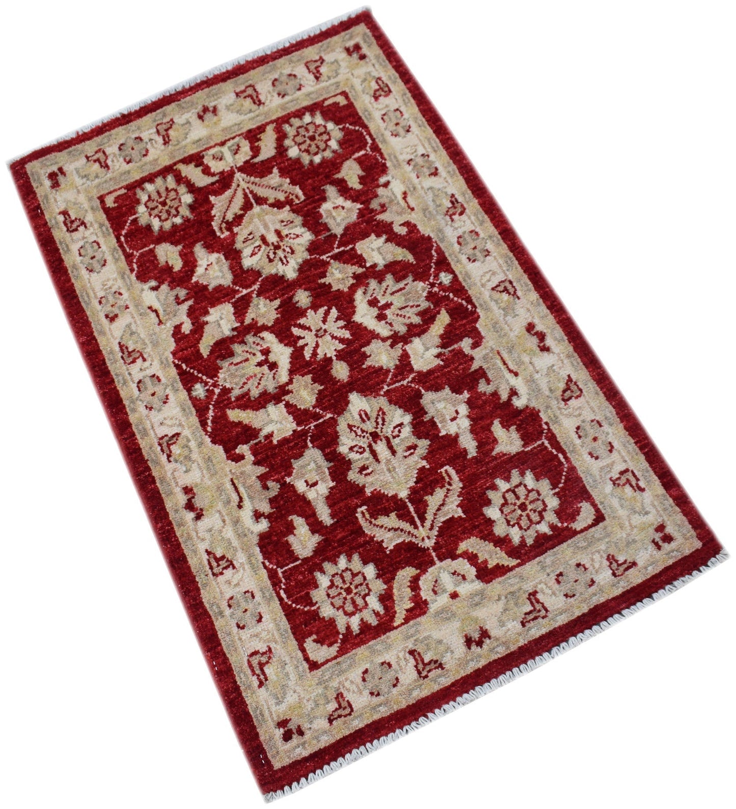 A handmade Afghan Chobi rug featuring a floral pattern in cream on a deep red background.