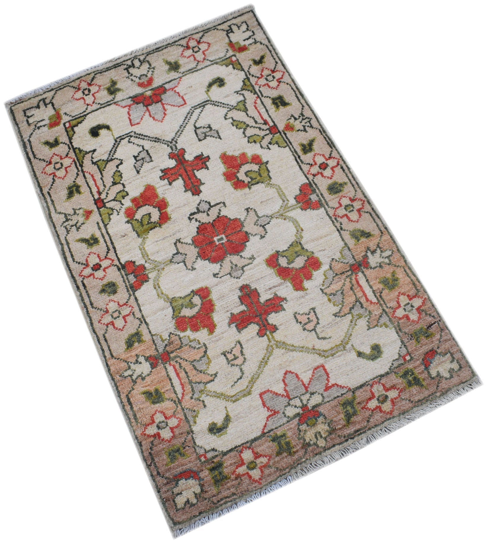 A handmade Afghan Chobi rug featuring a floral pattern in red, green, and beige on a cream field.