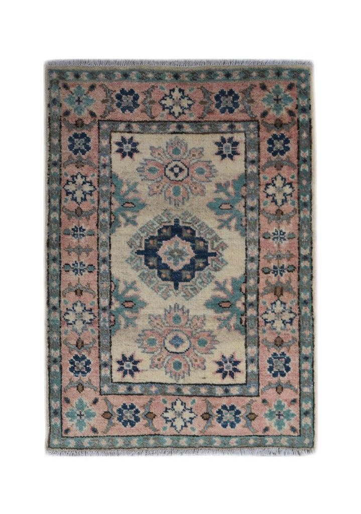 A handmade wool Afghan Kazakh rug featuring a central medallion in blue, pink, and cream tones.