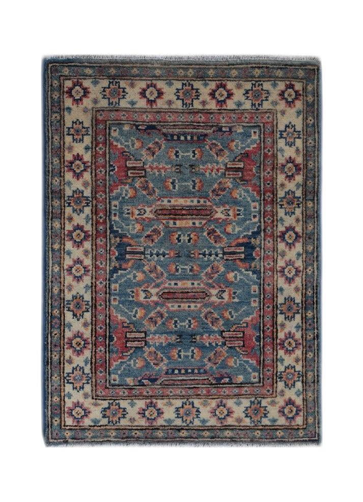 A handmade wool Afghan Kazakh rug featuring a blue and red geometric pattern on a cream border.